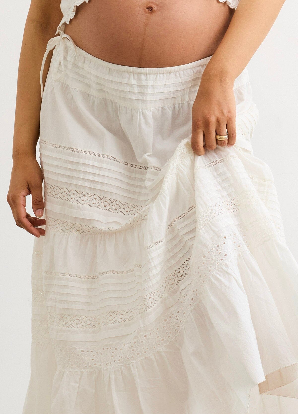 The Ada Skirt - White flowy maternity skirt with tiered lace details, designed for pregnancy, nursing, and postpartum comfort.