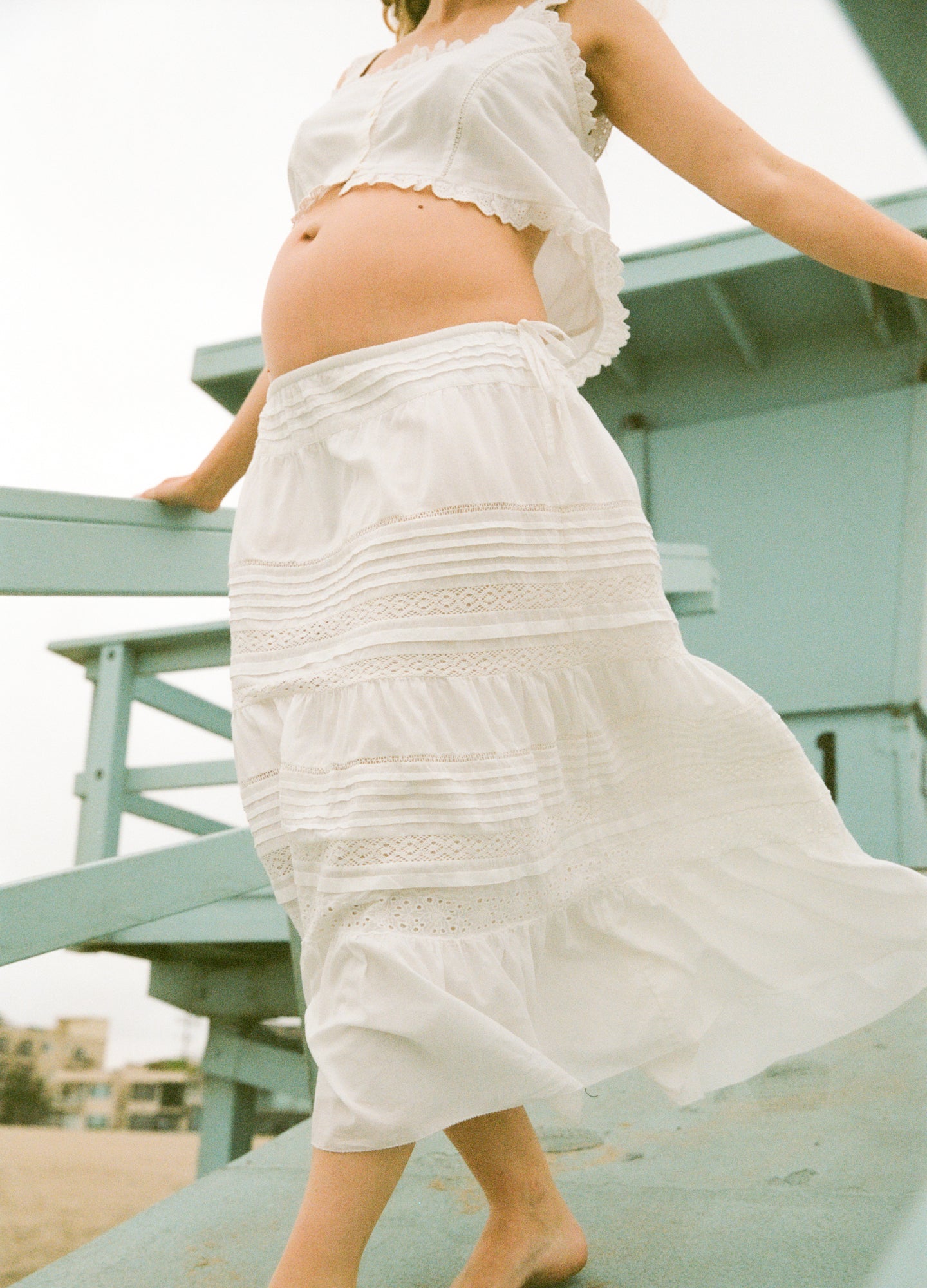 The Ada Skirt - White flowy maternity skirt with tiered lace details, designed for pregnancy, nursing, and postpartum comfort.