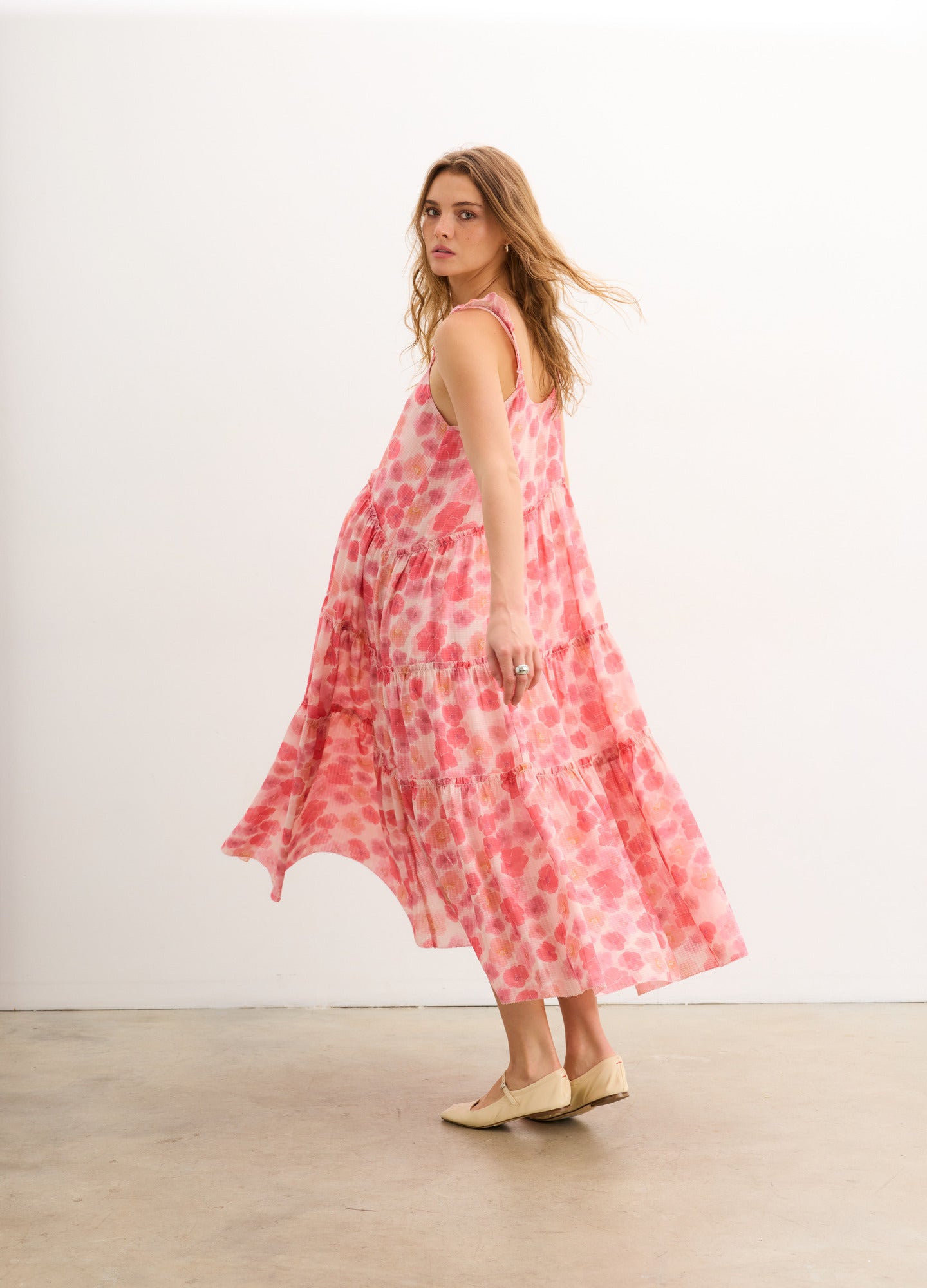 The Anaelle Dress - Flowy pink floral maternity dress with adjustable straps, designed for pregnancy, nursing, and postpartum comfort.