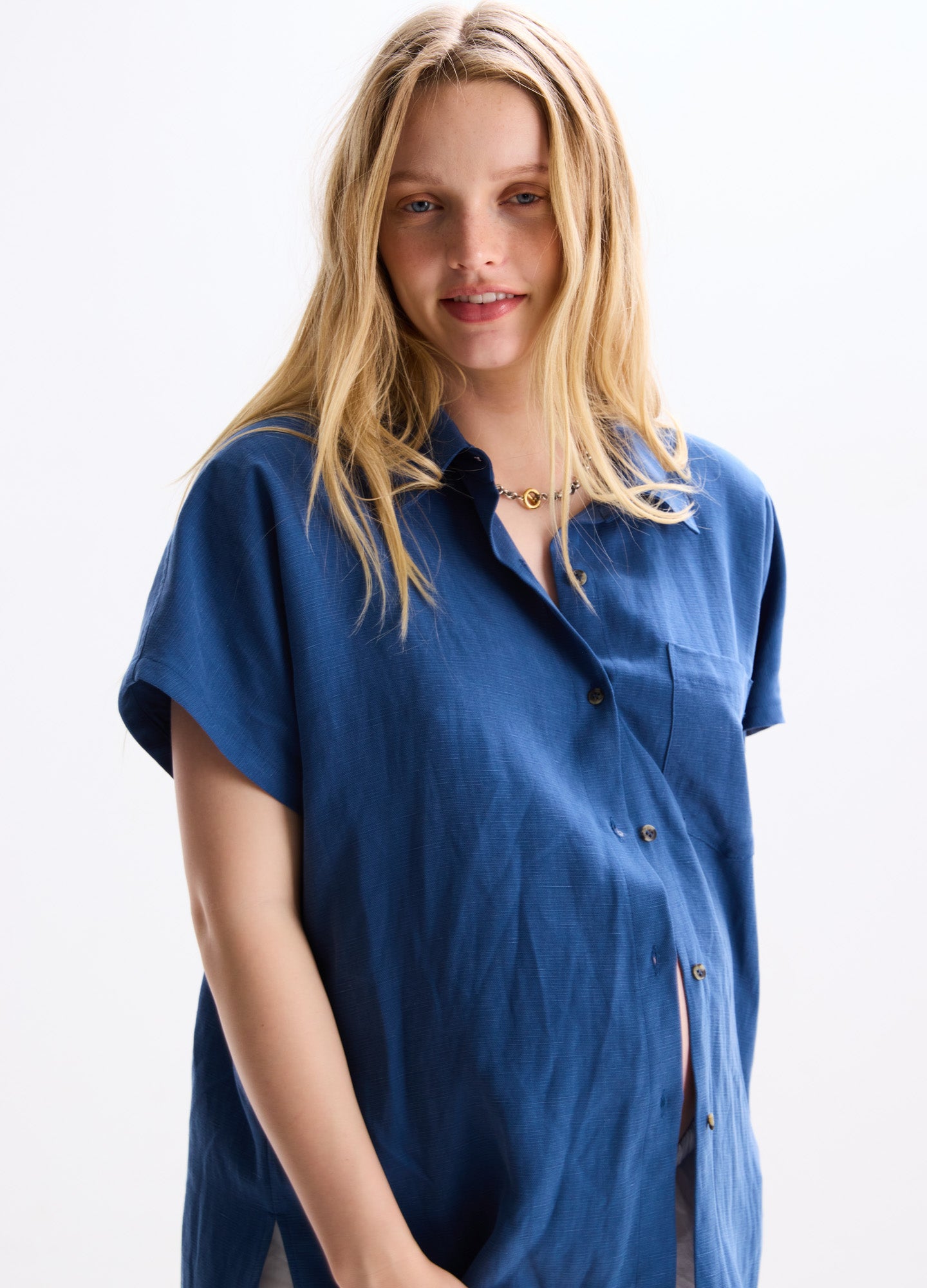 Blue short-sleeve maternity shirt with front buttons and loose fit for pregnant women.