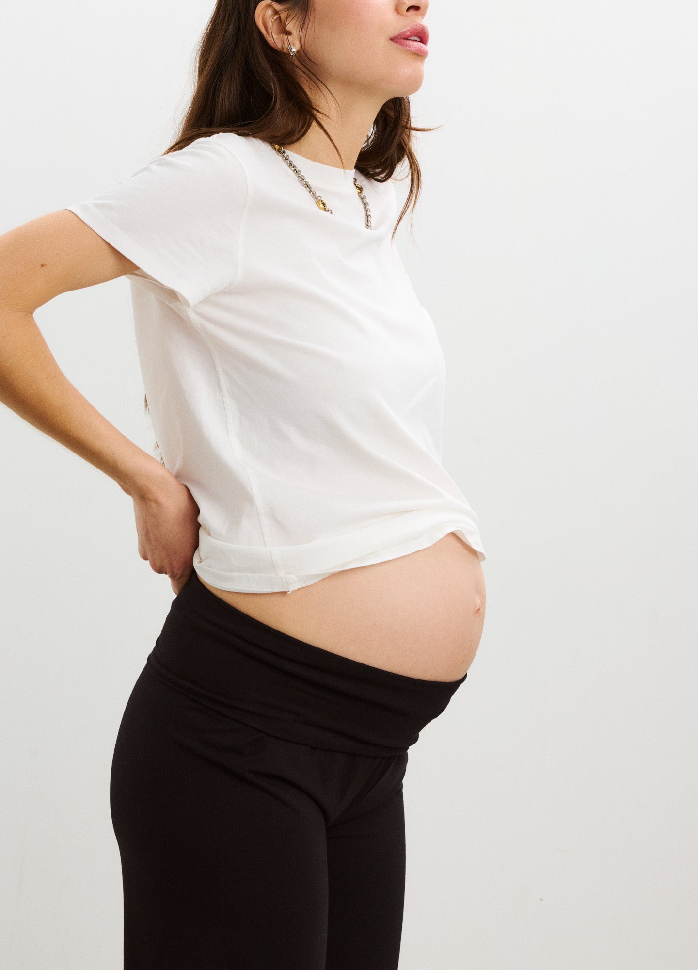 Black stretch maternity leggings with high supportive waistband designed for pregnancy comfort.