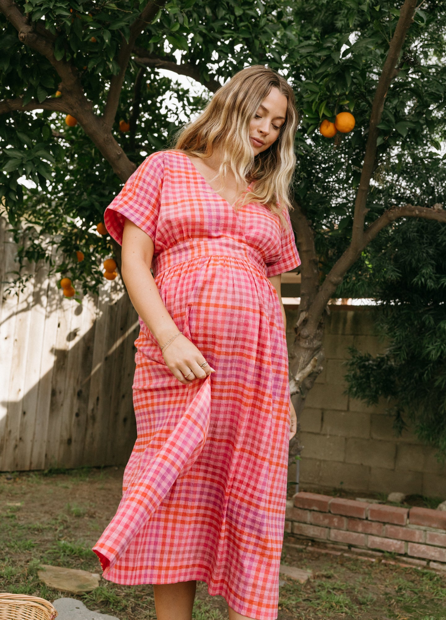 Pink and orange plaid maternity dress with short sleeves and a V-neck, flowy and ankle-length.