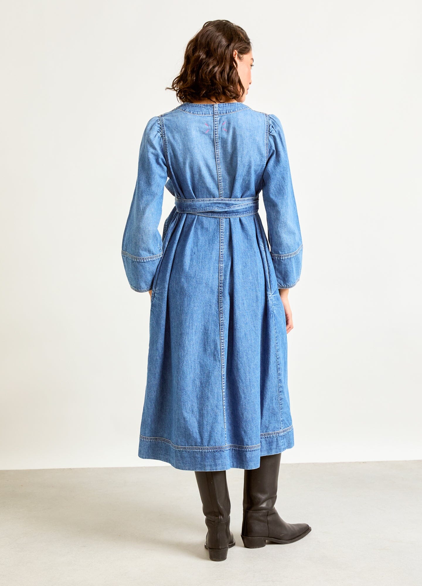The Denim Carolina Dress - Indigo denim Carolina dress with adjustable waist tie, long sleeves, designed for maternity, nursing, and postpartum wear.