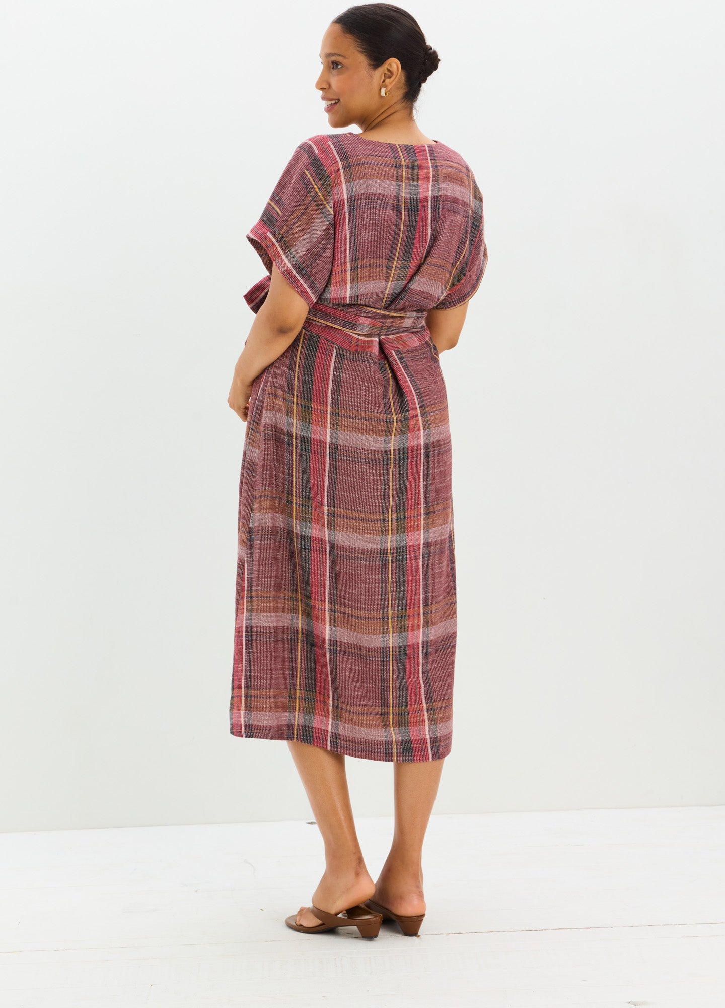 Maternity dress in rust plaid with short sleeves and mid-length hem, tied waist detail.