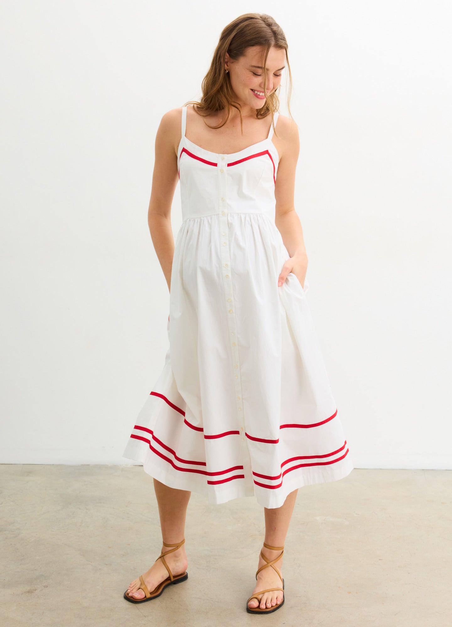 The Catalina Dress - White and red maternity dress with front buttons, adjustable straps, and a gathered waist for nursing and postpartum comfort.