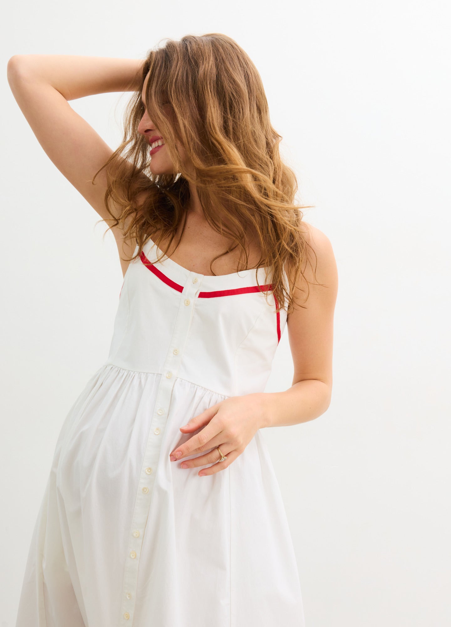The Catalina Dress - White and red maternity dress with front buttons, adjustable straps, and a gathered waist for nursing and postpartum comfort.