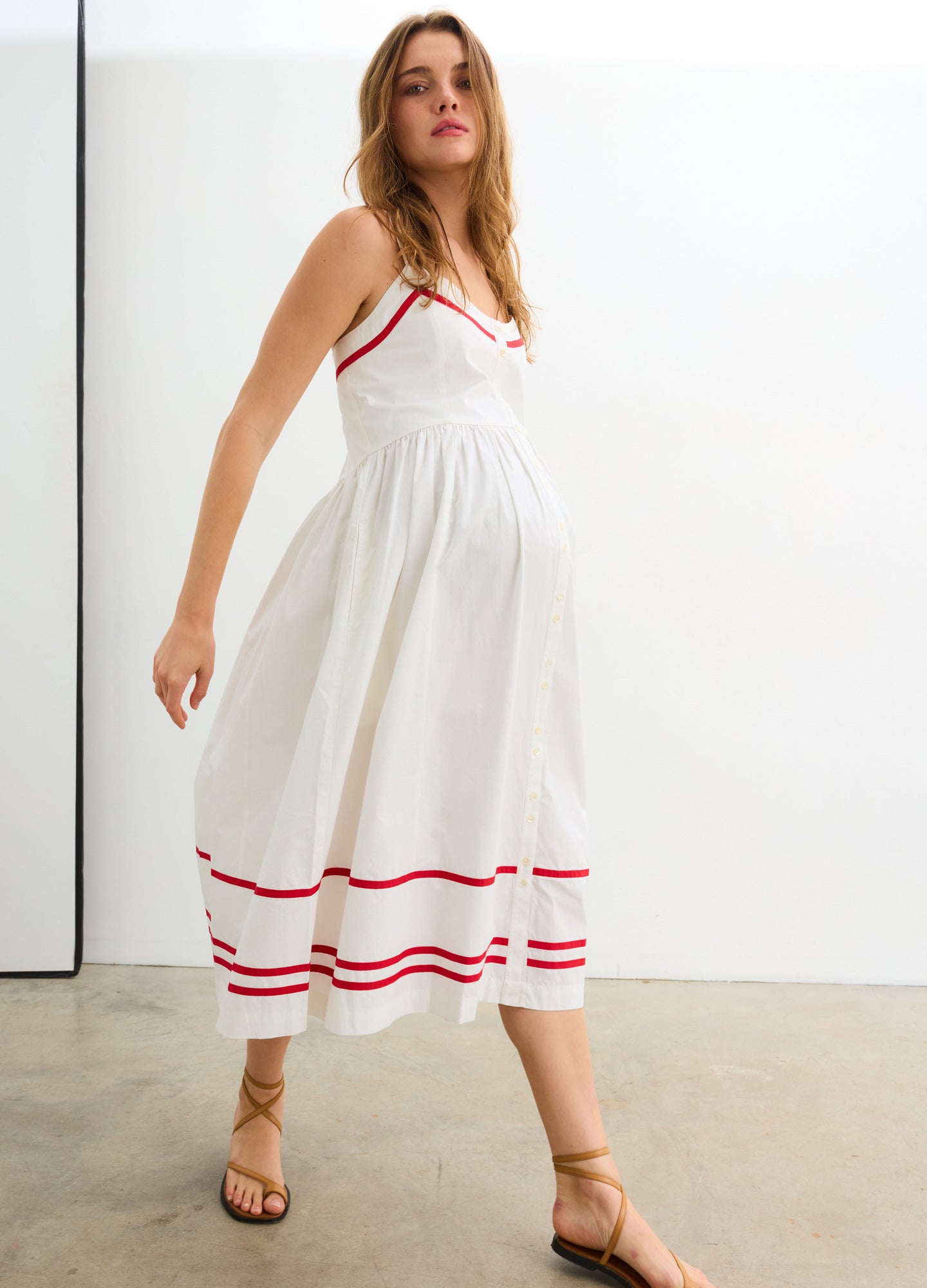 The Catalina Dress - White and red maternity dress with front buttons, adjustable straps, and a gathered waist for nursing and postpartum comfort.