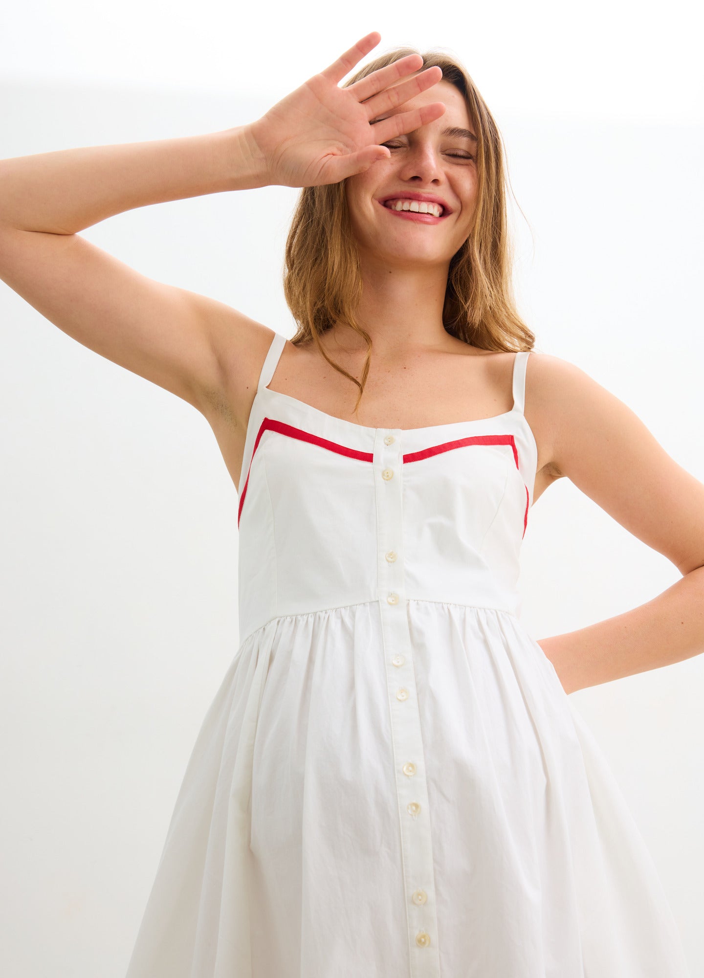 The Catalina Dress - White and red maternity dress with front buttons, adjustable straps, and a gathered waist for nursing and postpartum comfort.