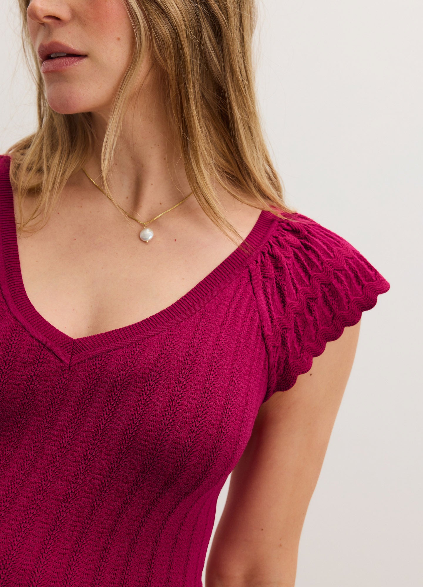 Fuchsia ribbed knit maternity dress with scalloped cap sleeves and a scoop neckline.