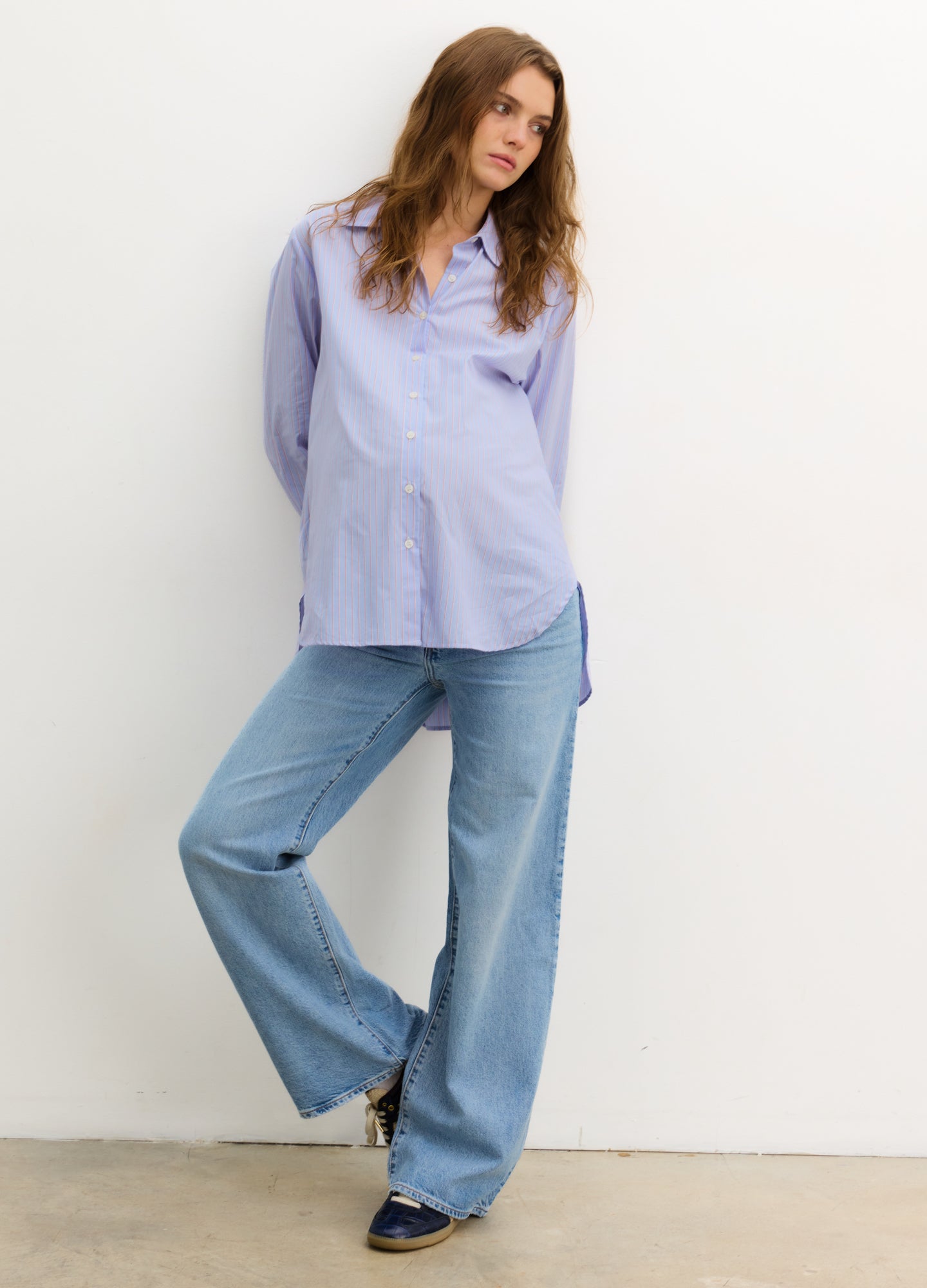 The Classic Buttondown - Blue multi-stripe maternity buttondown shirt with roll-tab sleeves, designed for nursing and postpartum wear.