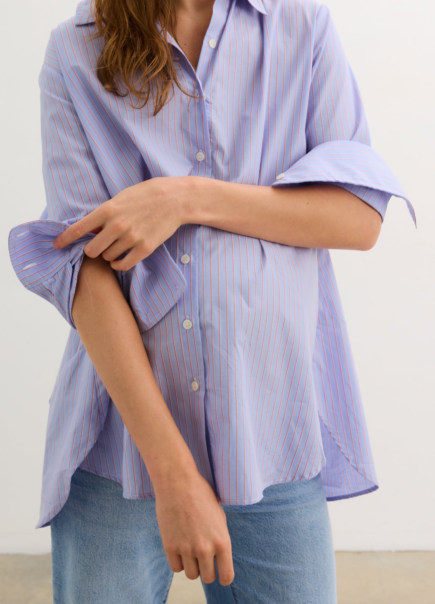 The Classic Buttondown - Blue multi-stripe maternity buttondown shirt with roll-tab sleeves, designed for nursing and postpartum wear.