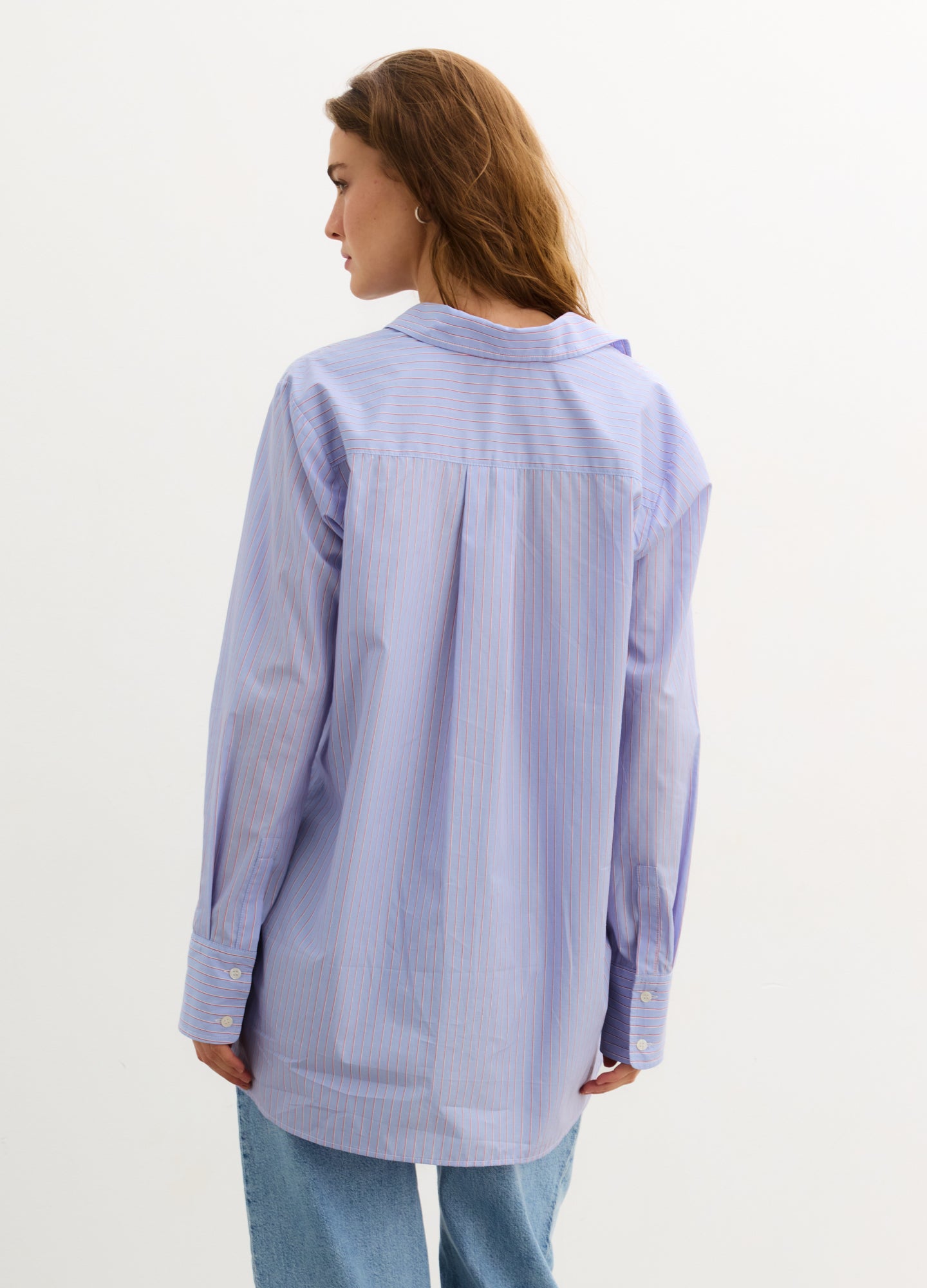 The Classic Buttondown - Blue multi-stripe maternity buttondown shirt with roll-tab sleeves, designed for nursing and postpartum wear.
