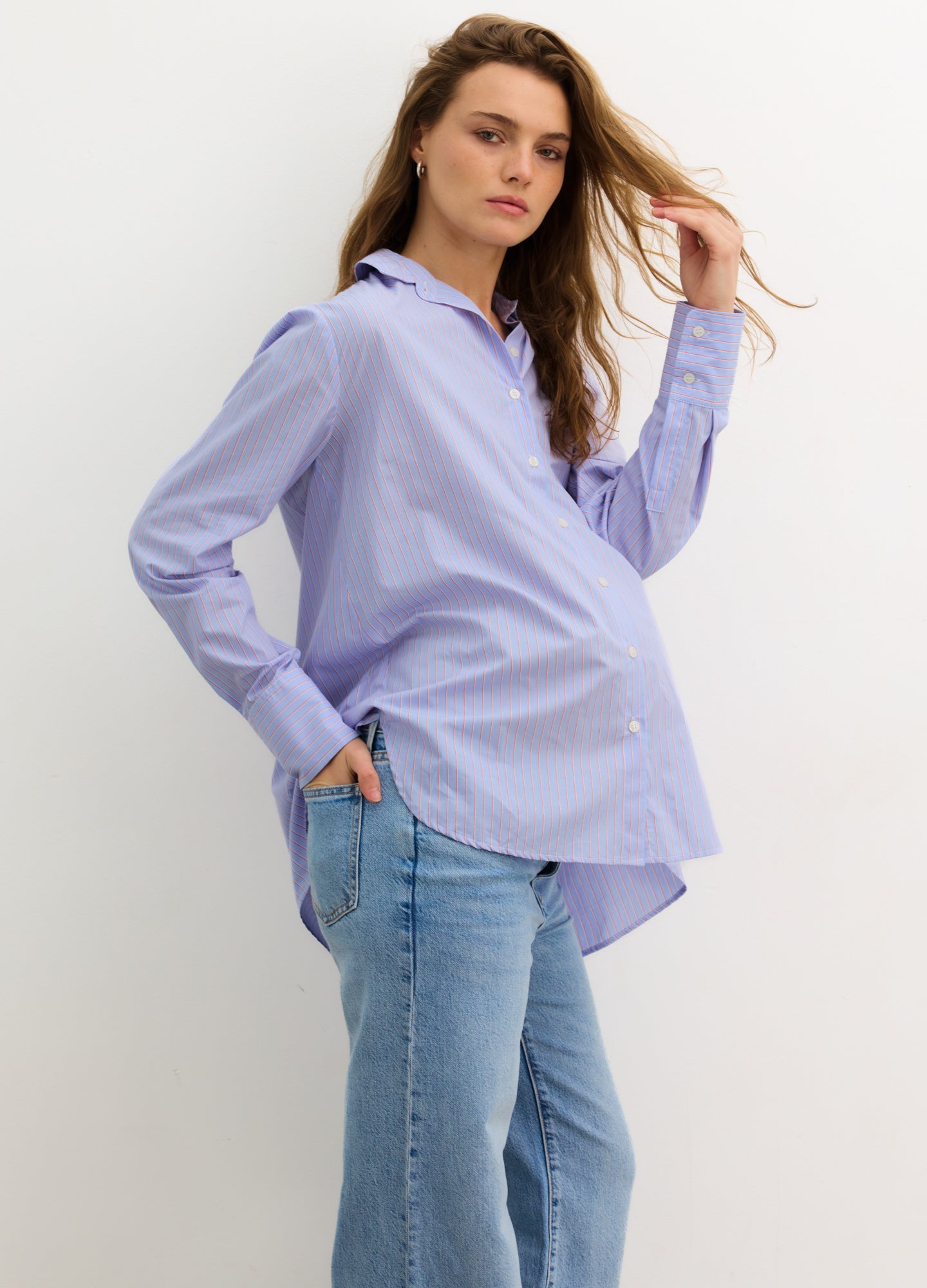 The Classic Buttondown - Blue multi-stripe maternity buttondown shirt with roll-tab sleeves, designed for nursing and postpartum wear.