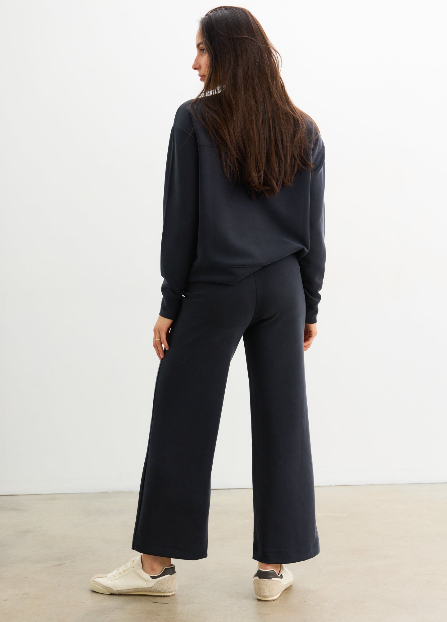 Black wide-leg maternity pants with elastic waistband made from soft, comfortable fabric.