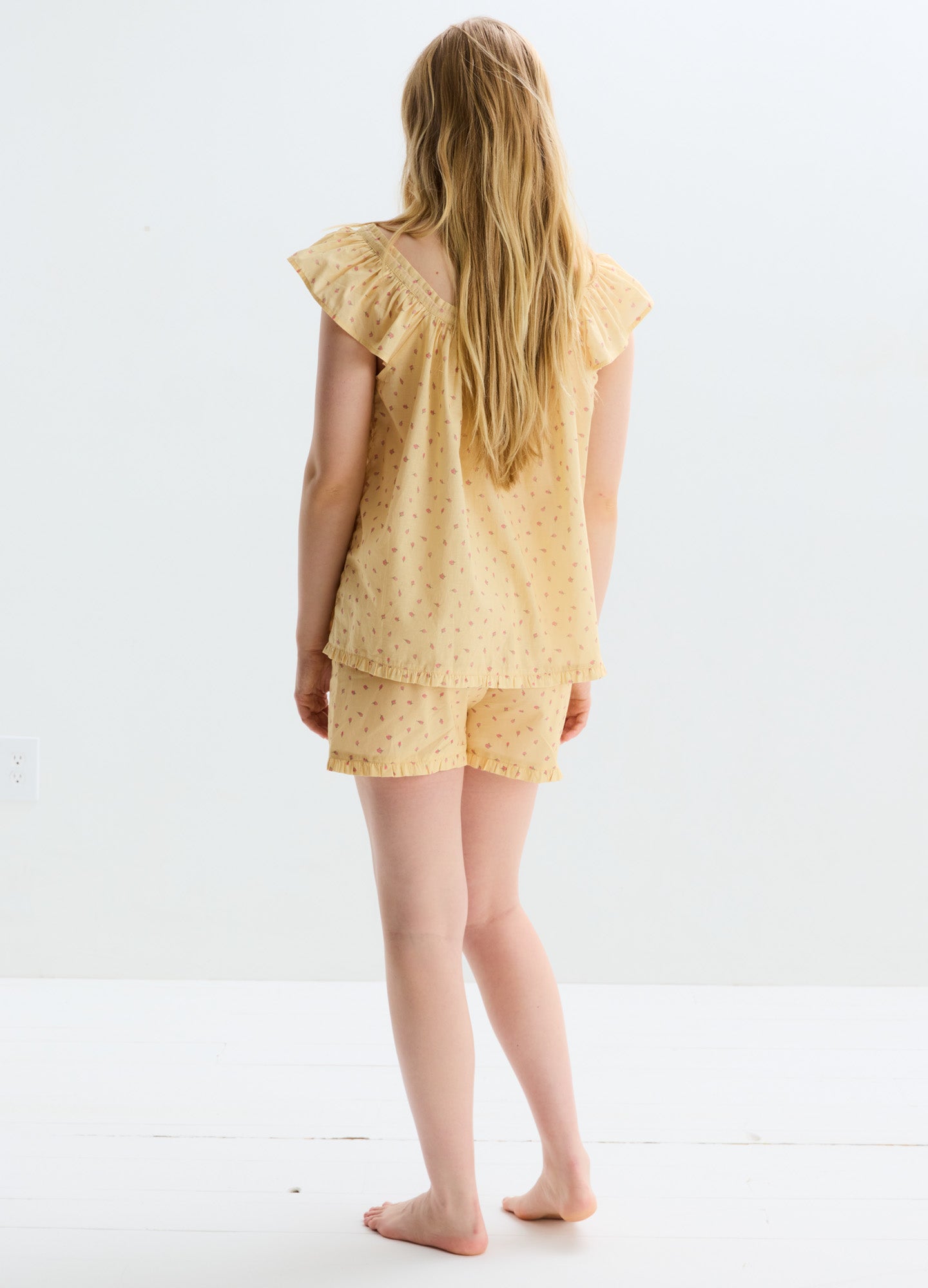 Light yellow cotton nursing pajama set with short flutter sleeves and matching shorts, subtle eyelet pattern.