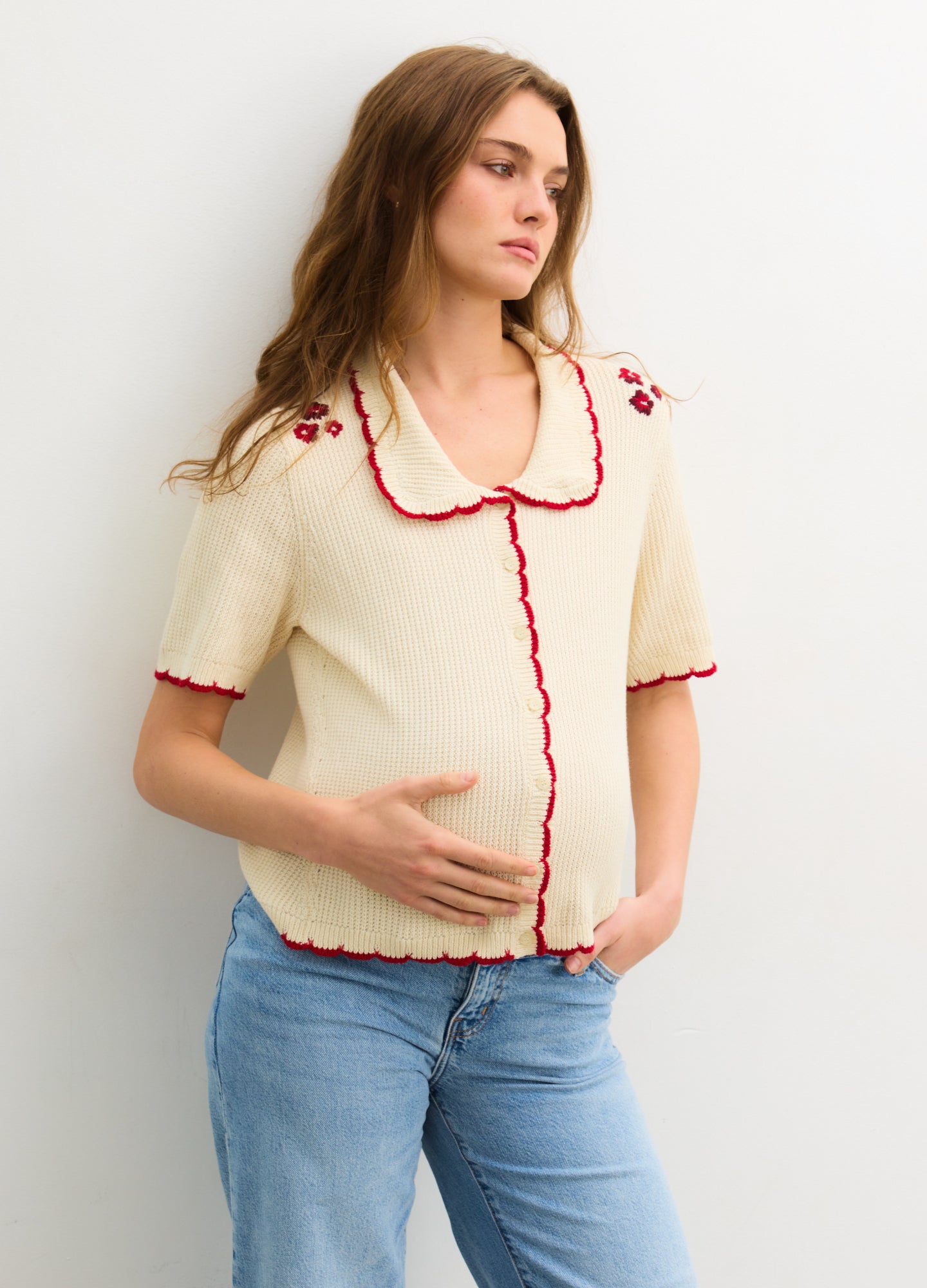 The Crochet Scallop Cardigan - Cream crochet scallop cardigan with red trim, short sleeves, and nursing-friendly front buttons for maternity and postpartum .