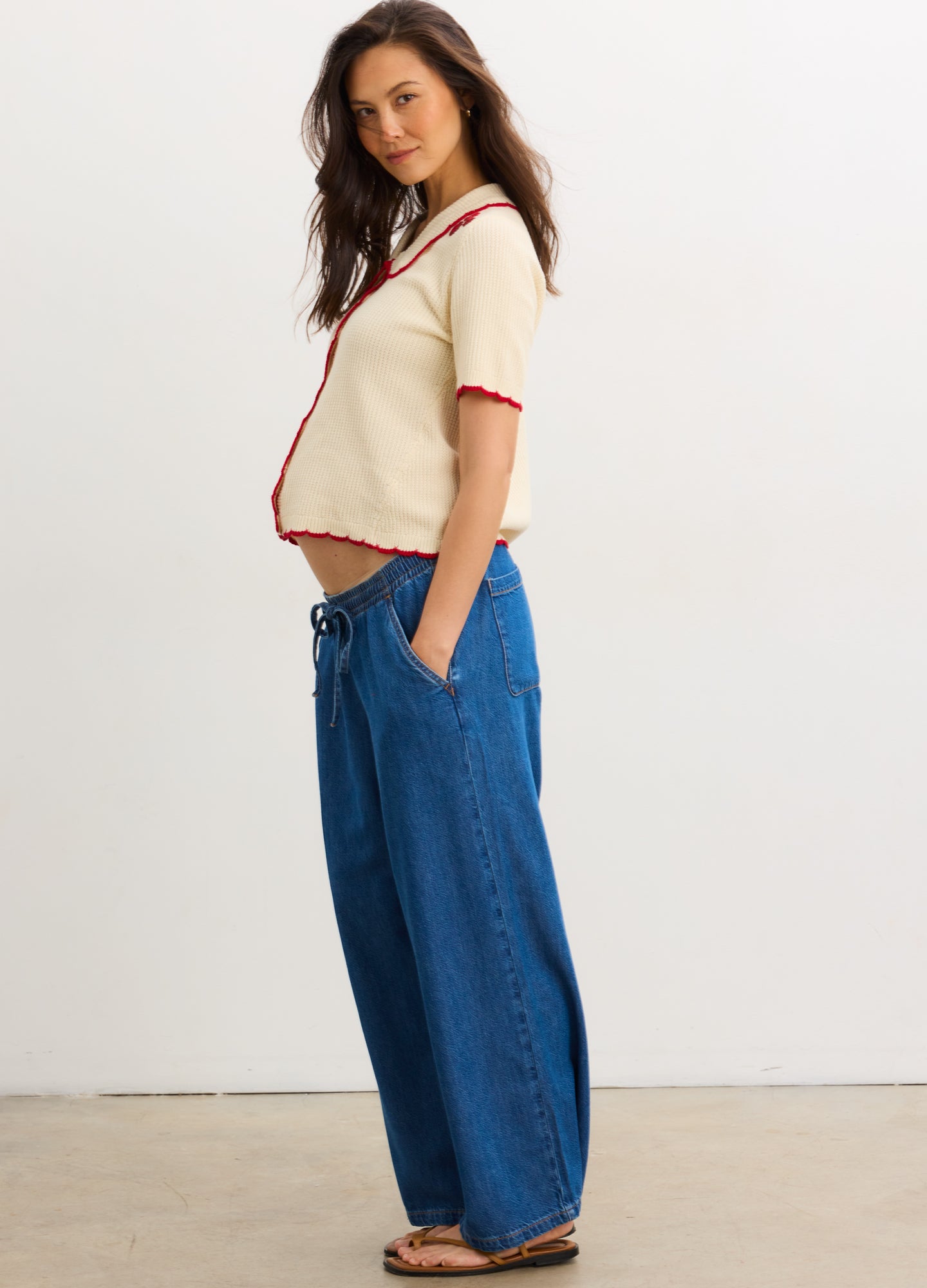 The Crochet Scallop Cardigan - Cream crochet scallop cardigan with red trim, short sleeves, and nursing-friendly front buttons for maternity and postpartum .