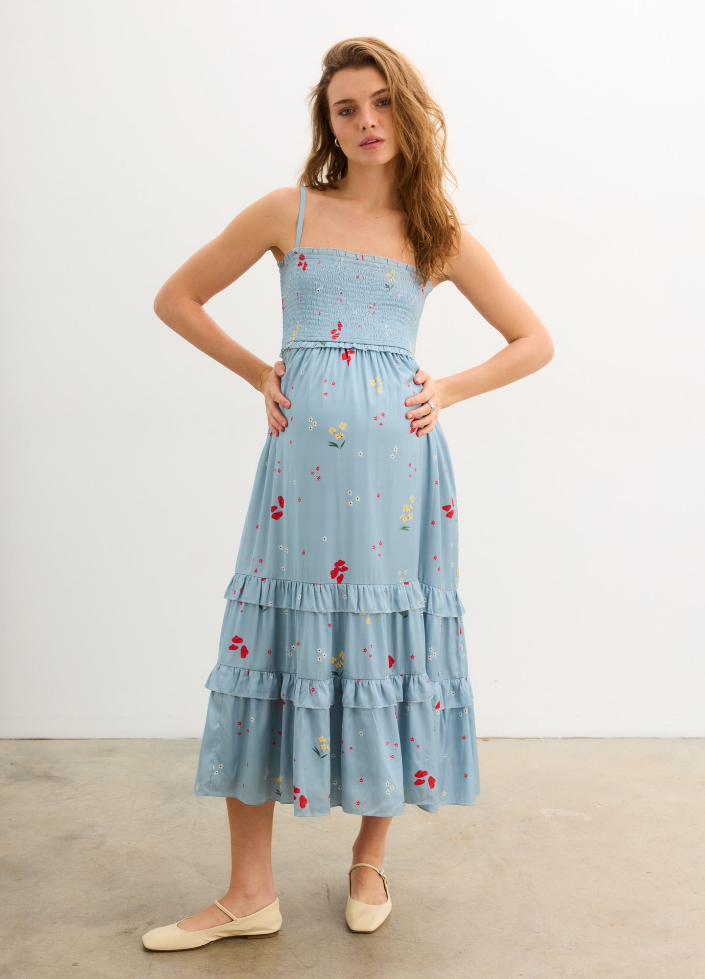 The Dani Dress - Stone blue maternity dress with red poppy print, adjustable straps, and tiered skirt for nursing and postpartum comfort.