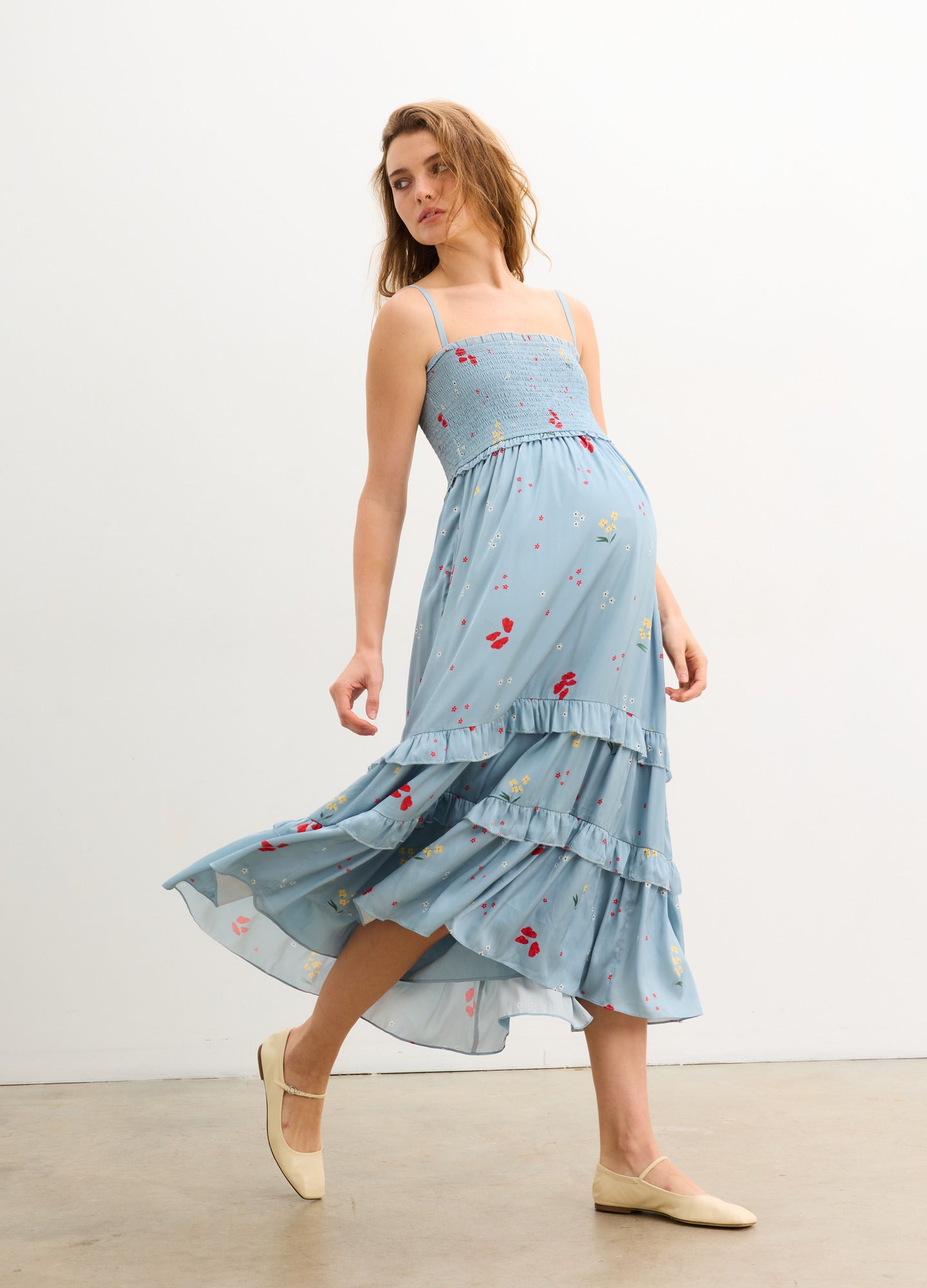 The Dani Dress - Stone blue maternity dress with red poppy print, adjustable straps, and tiered skirt for nursing and postpartum comfort.