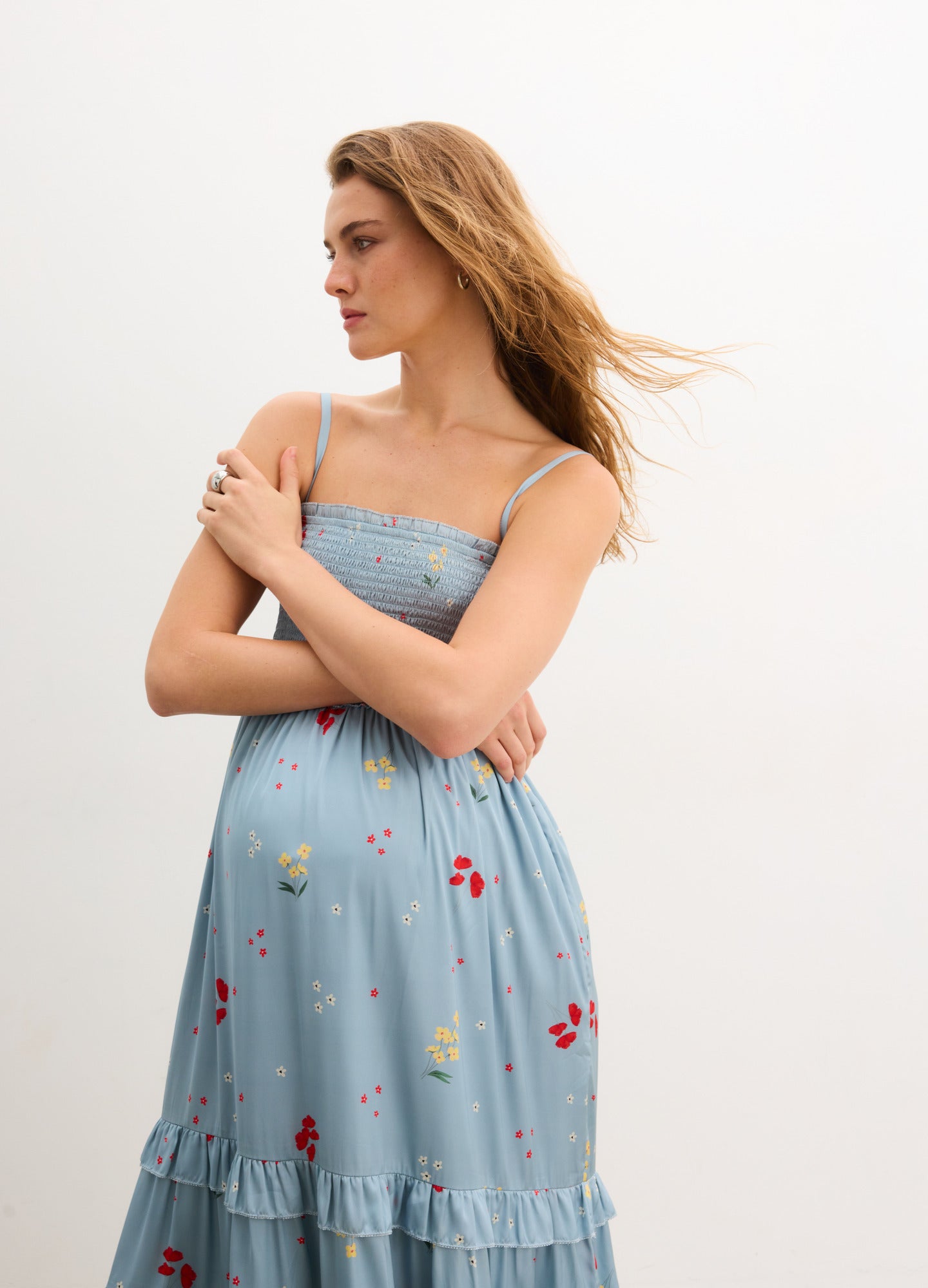 The Dani Dress - Stone blue maternity dress with red poppy print, adjustable straps, and tiered skirt for nursing and postpartum comfort.