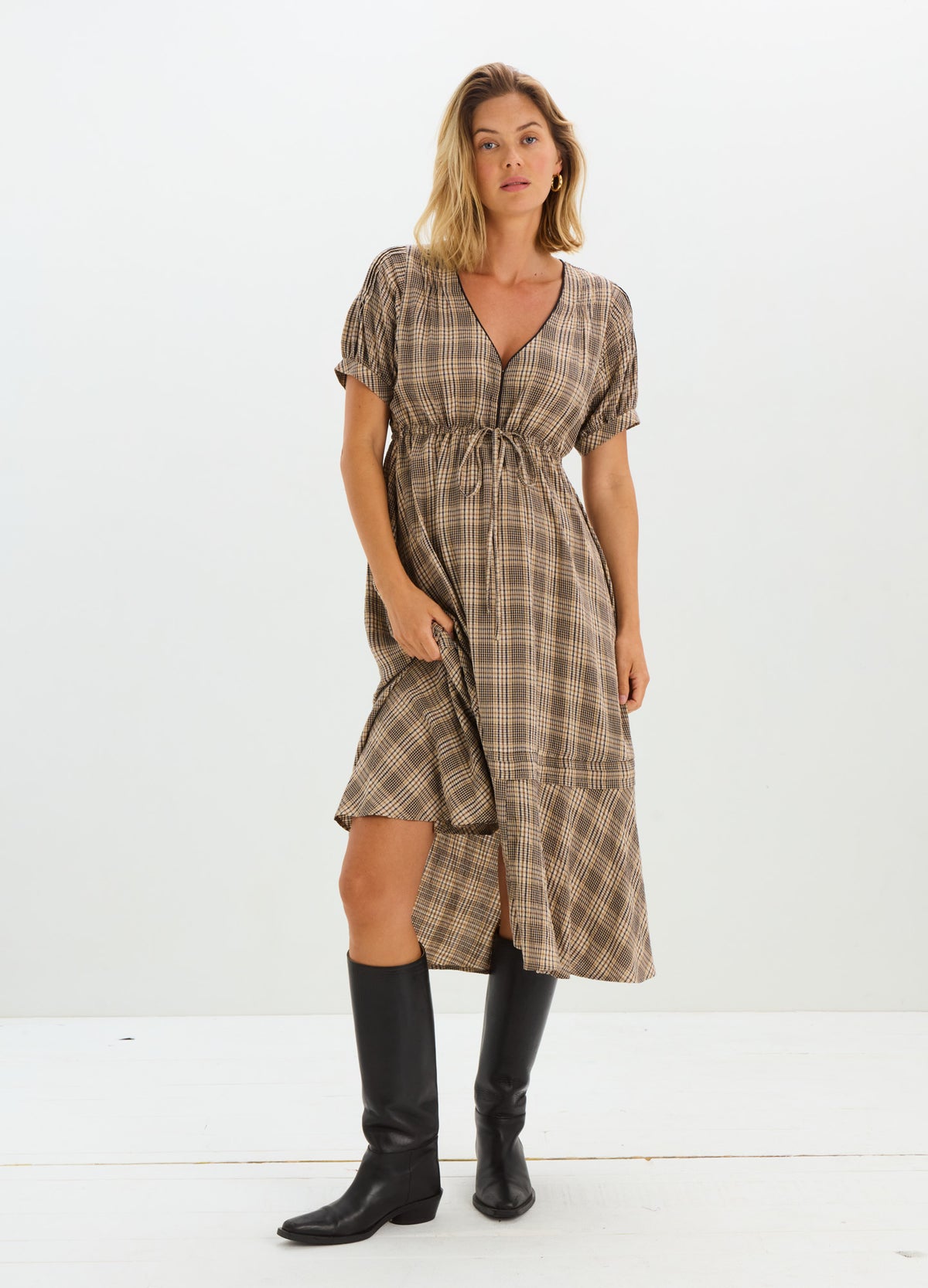 Plaid midi nursing dress with short puff sleeves and wrap front, styled for maternity with side slit, paired with black.