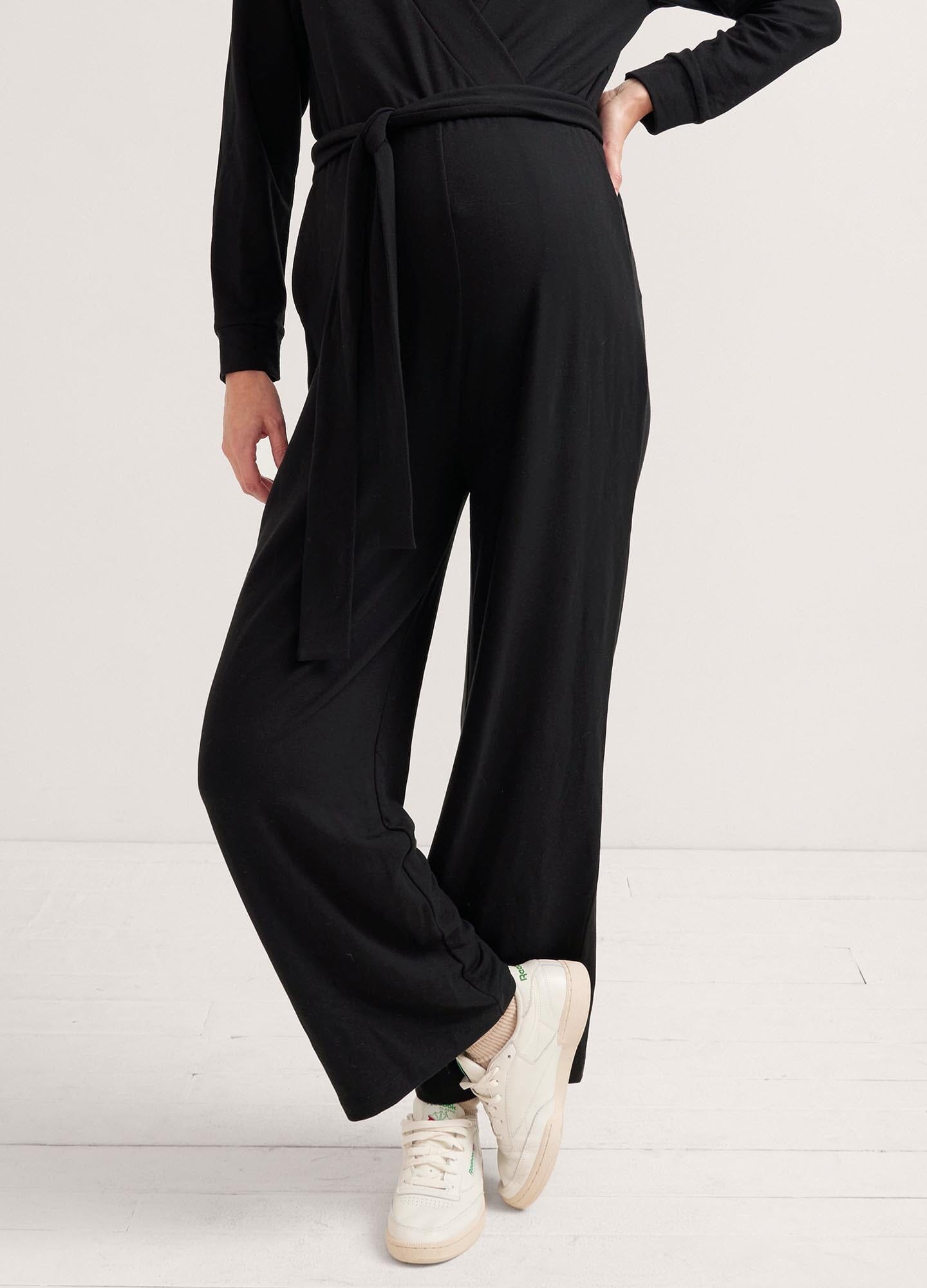 The Easy Nursing Jumpsuit - Black maternity jumpsuit with long sleeves, nursing-friendly front zipper, and relaxed wide-leg fit for postpartum comfort.