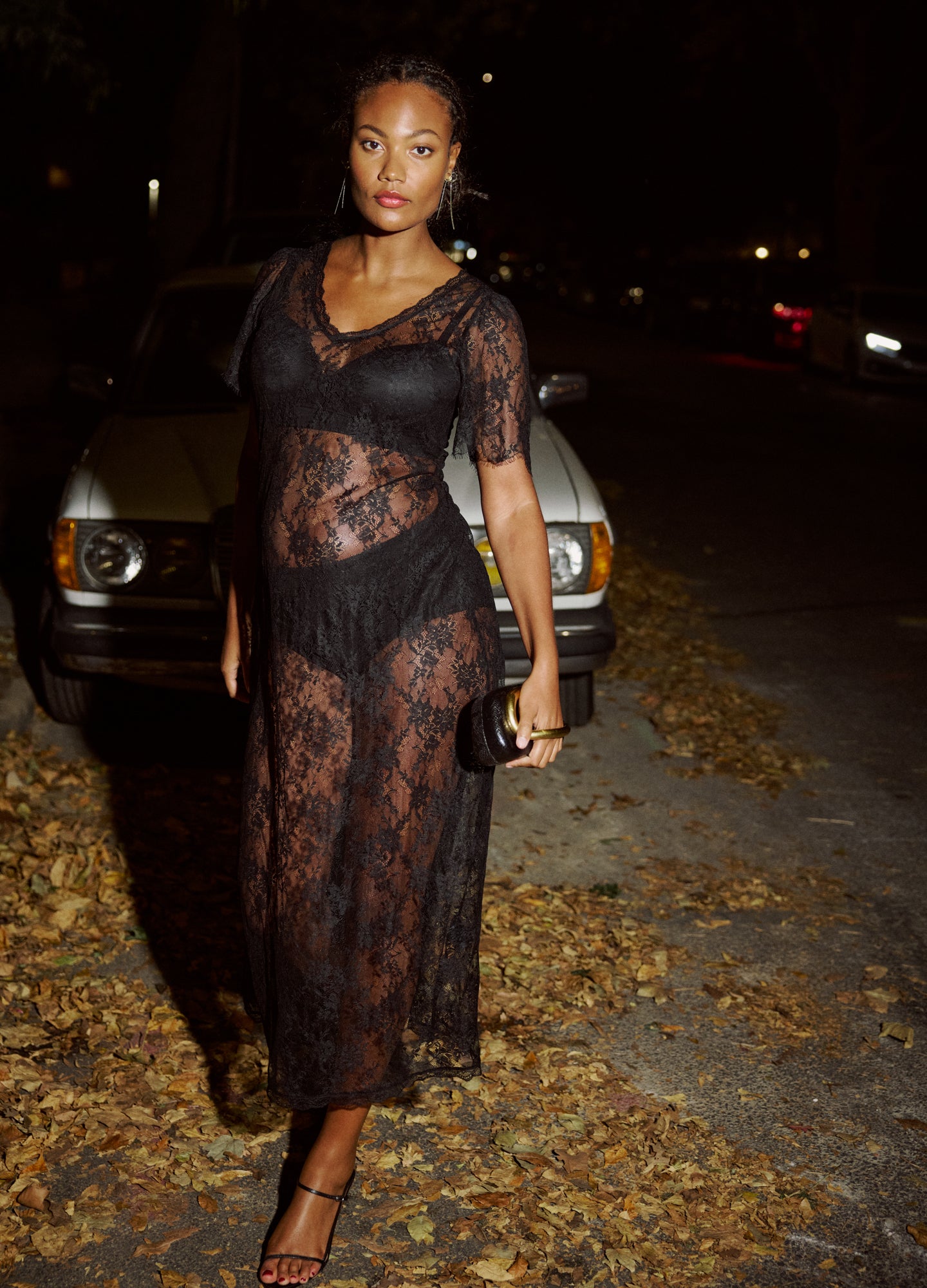 Black lace maternity dress with sheer floral pattern, V-neck and short sleeves, styled for pregnant women.