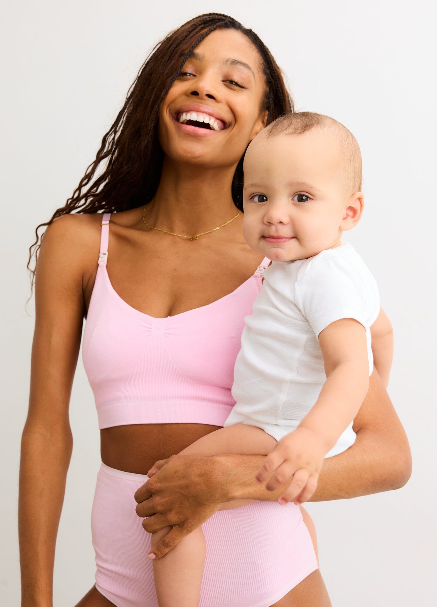 The Essential Nursing And Pumping Bra - Soft pink nursing bra with adjustable straps, designed for maternity and postpartum comfort.