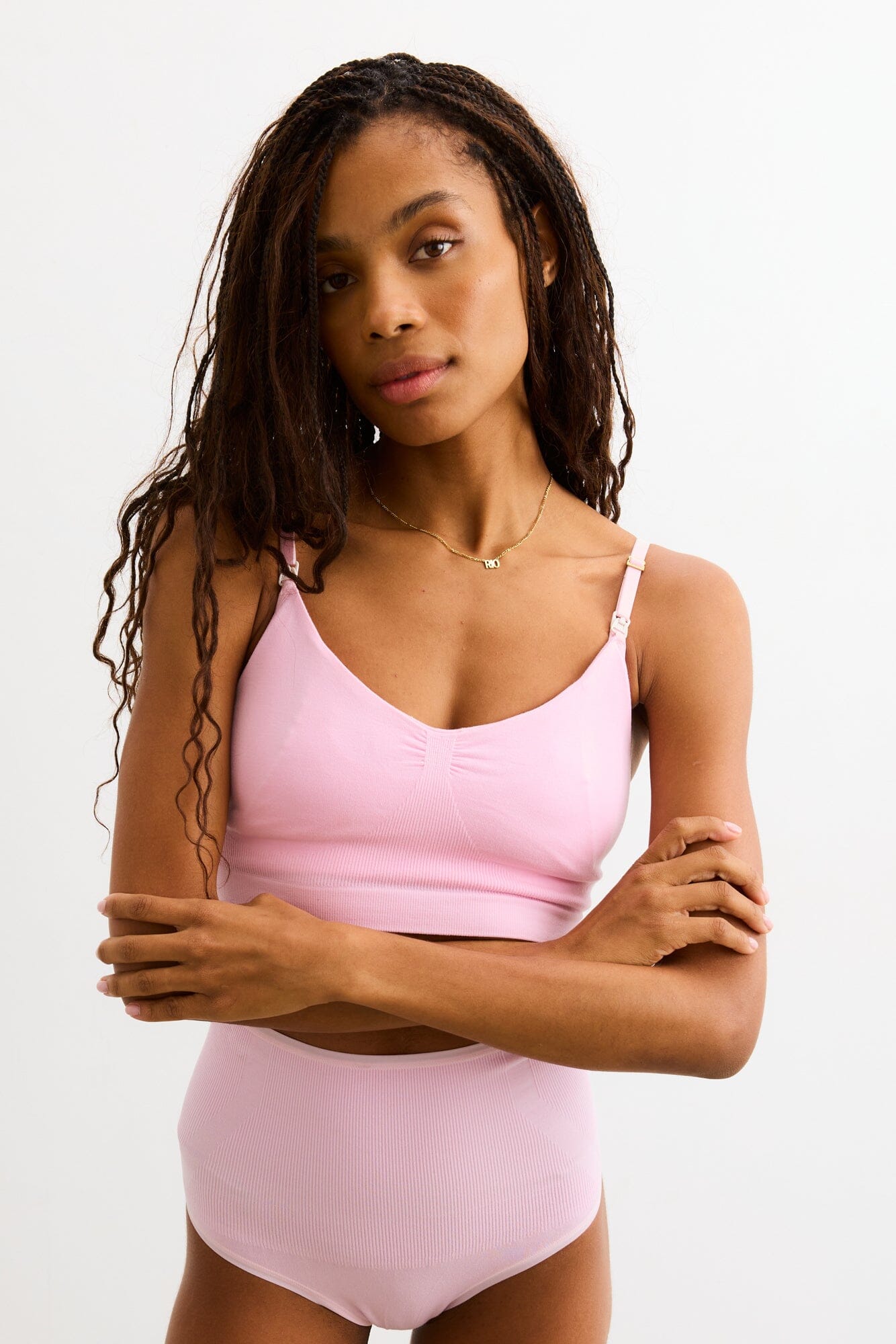 The Essential Nursing And Pumping Bra - Soft pink nursing bra with adjustable straps, designed for maternity and postpartum comfort.