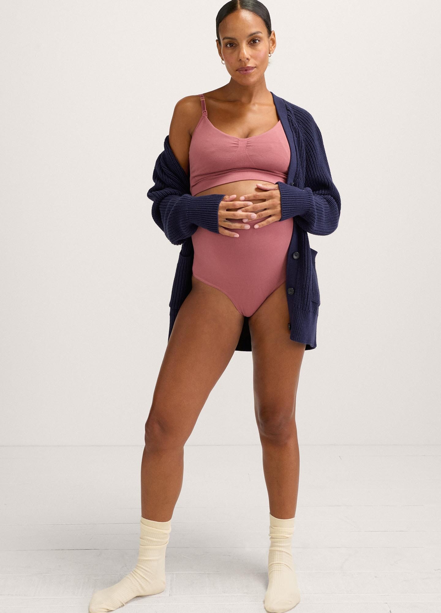 Mauve seamless maternity pumping bra with wide straps and supportive fit worn under navy cardigan.