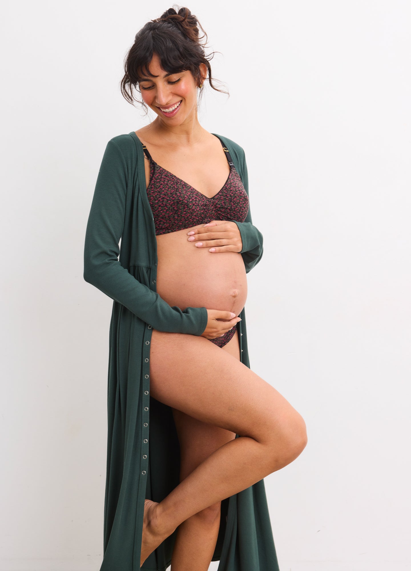 Soft black lace nursing bra with supportive cups and adjustable straps, modeled by a pregnant woman.