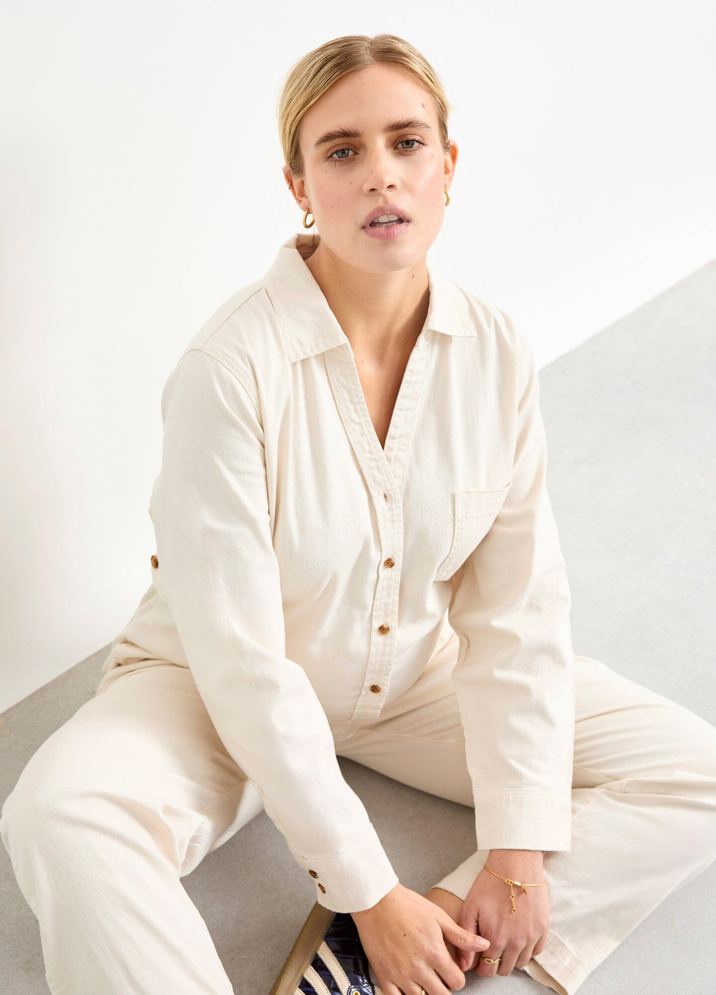 The Everyday Nursing Denim Jumpsuit - Vanilla maternity denim jumpsuit with button-front nursing access, relaxed fit for pregnancy and postpartum.