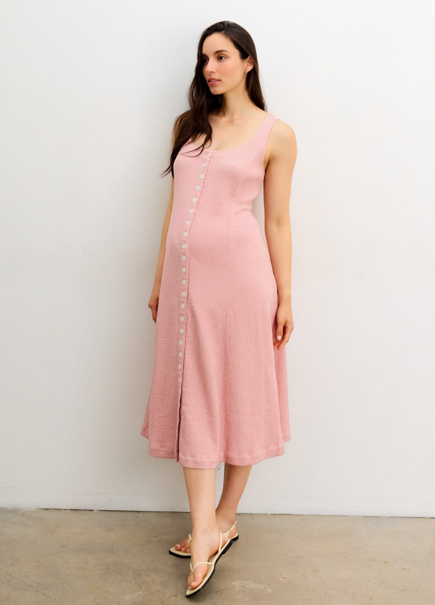 The Felicity Dress - Soft pink sleeveless maternity dress with front button closure, designed for nursing and postpartum comfort.