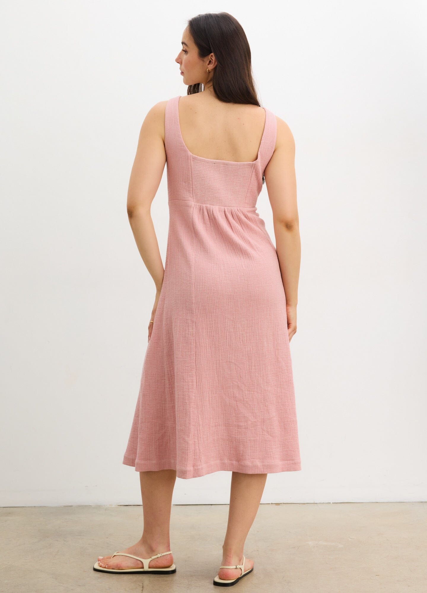 The Felicity Dress - Soft pink sleeveless maternity dress with front button closure, designed for nursing and postpartum comfort.