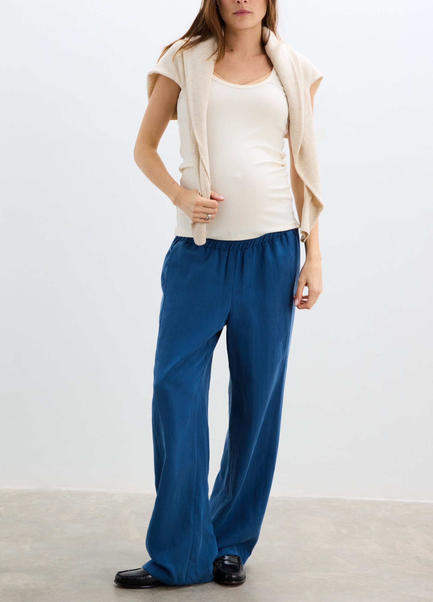 Blue maternity pants with a relaxed fit and elastic waistband designed for pregnancy comfort.