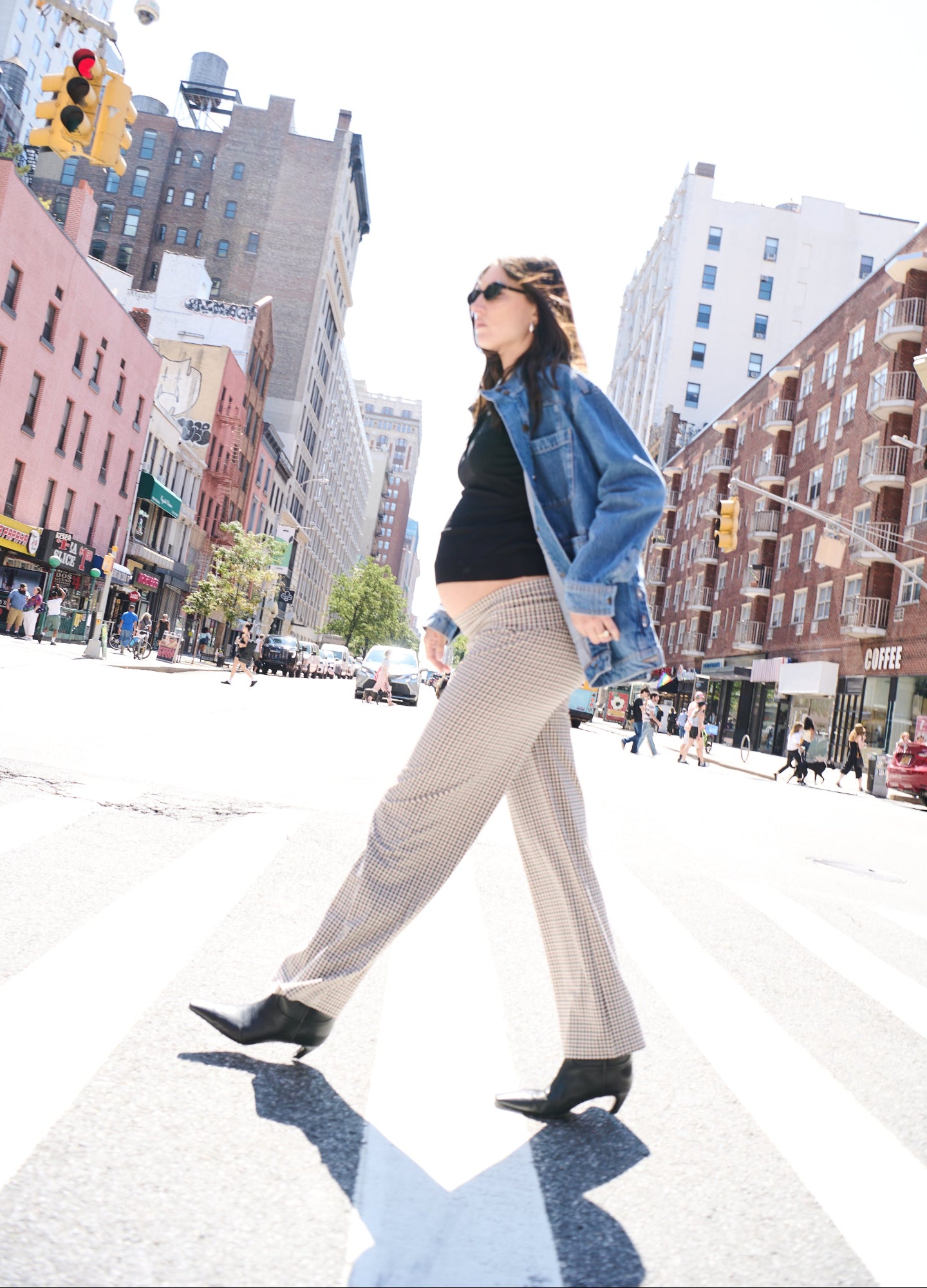 Beige maternity pants with a stretchy waistband, paired with a black top and a denim jacket, styled for pregnancy comfort.