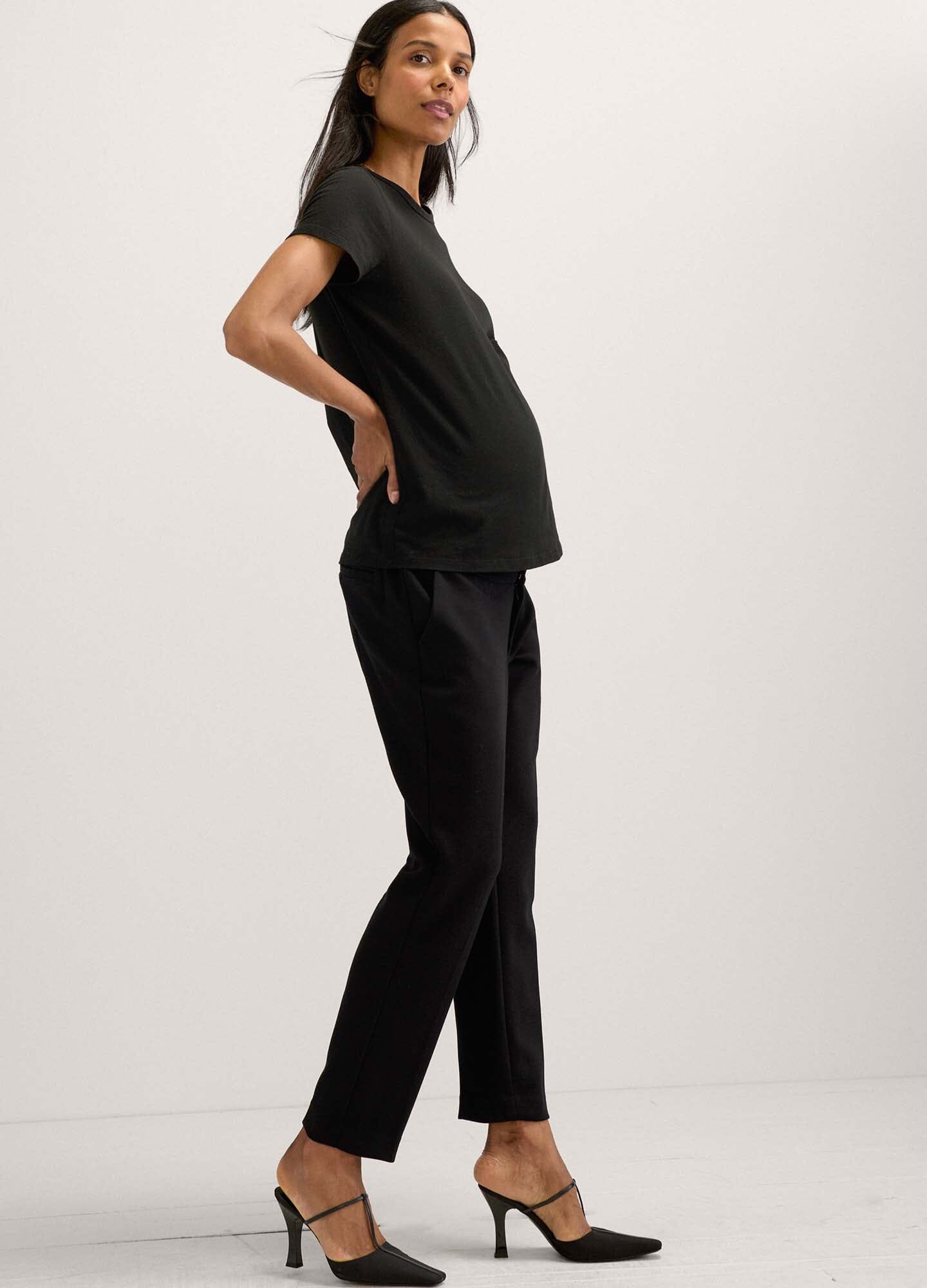 The HATCH Stretch Suit Pant - Black maternity stretch suit pants with tapered legs and front pockets, styled for pregnancy and postpartum wear.