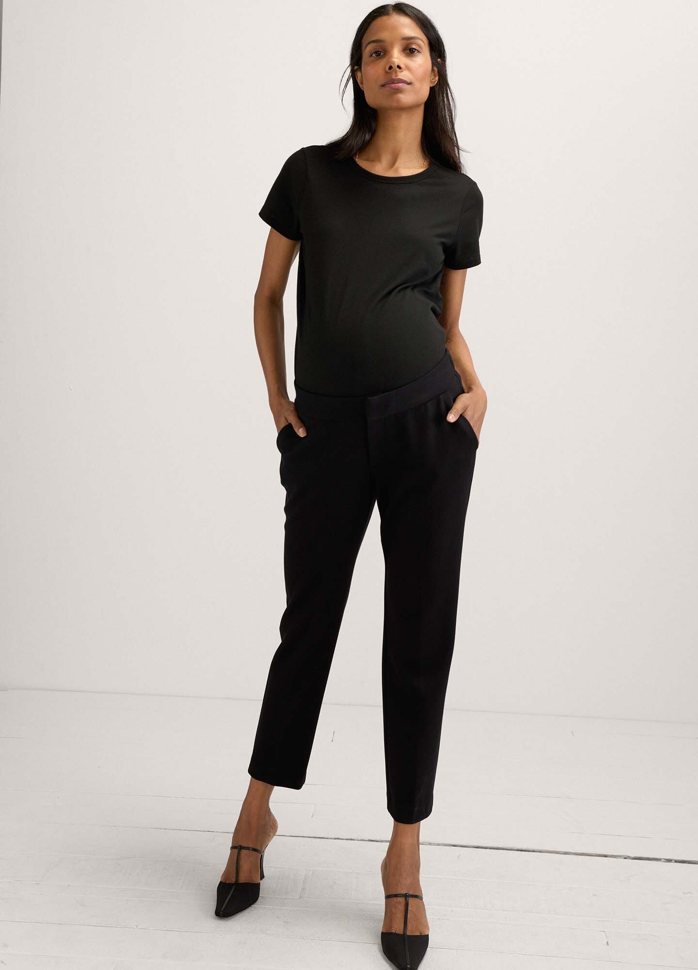 The HATCH Stretch Suit Pant - Black maternity stretch suit pants with tapered legs and front pockets, styled for pregnancy and postpartum wear.