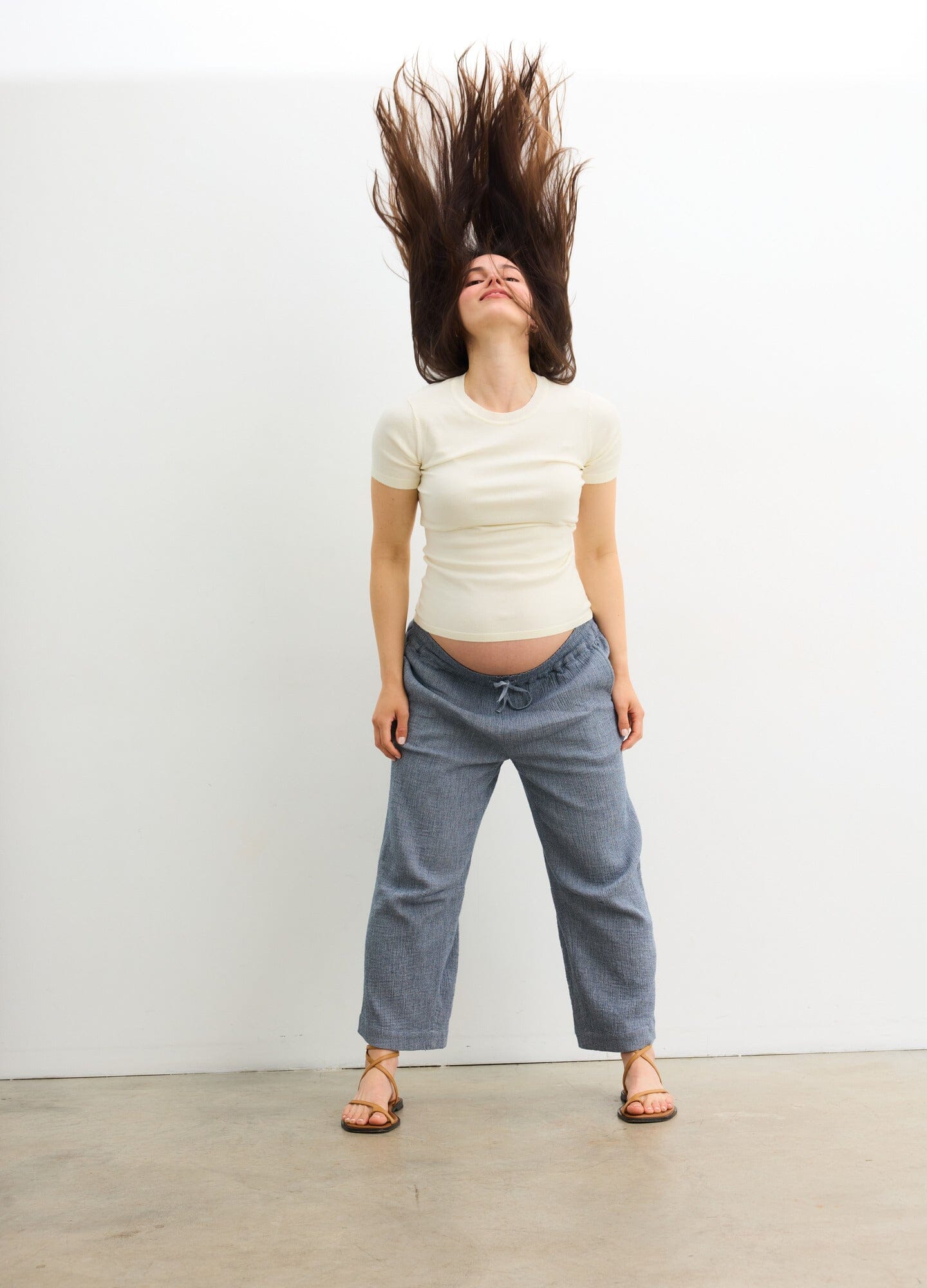 The Hayden Pant - Navy maternity pants with relaxed fit and elastic waistband, styled for pregnancy and postpartum comfort.