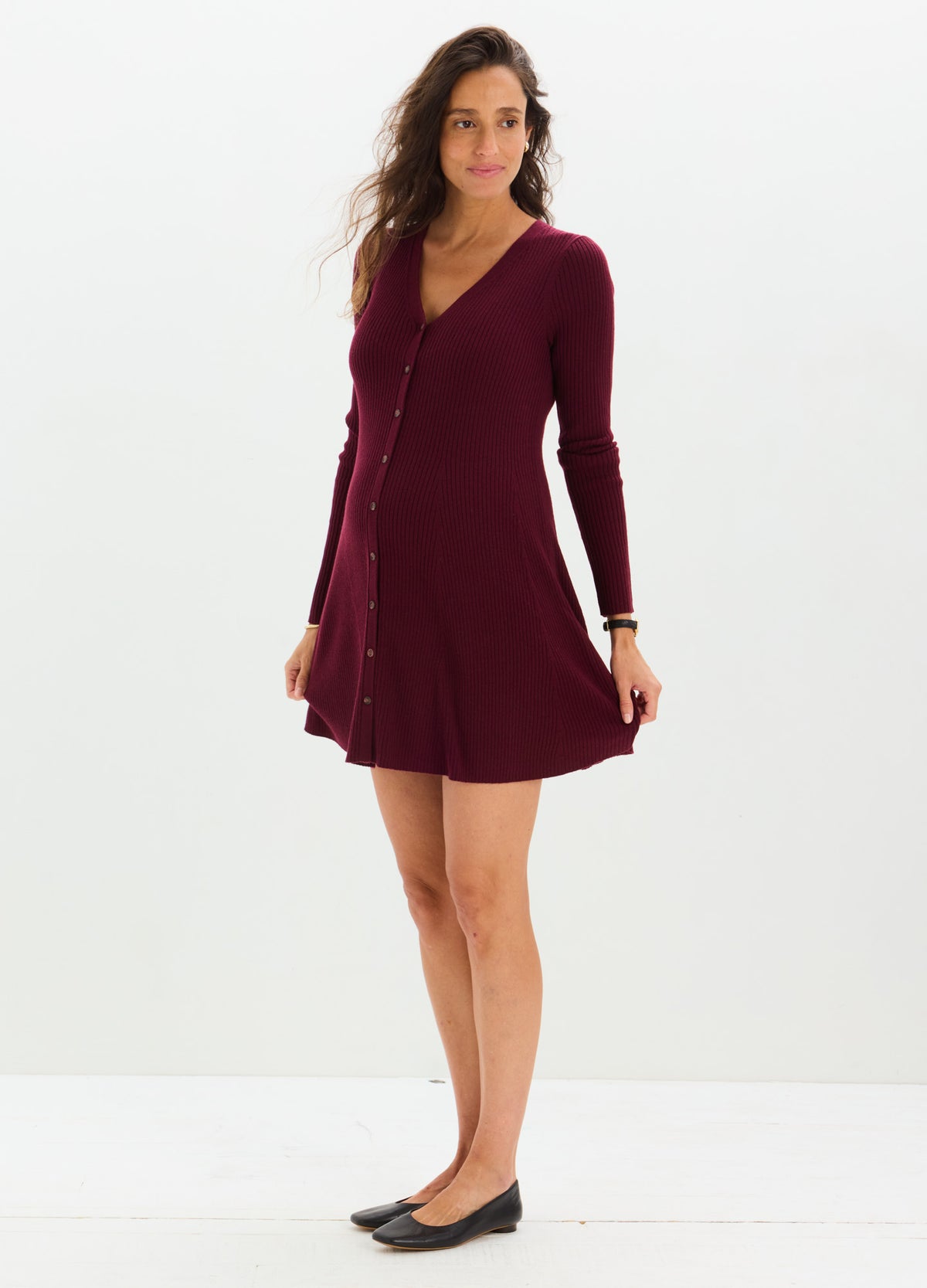 Burgundy long-sleeve knit mini sweater dress with a V-neck and button-down front, designed for maternity and nursing.