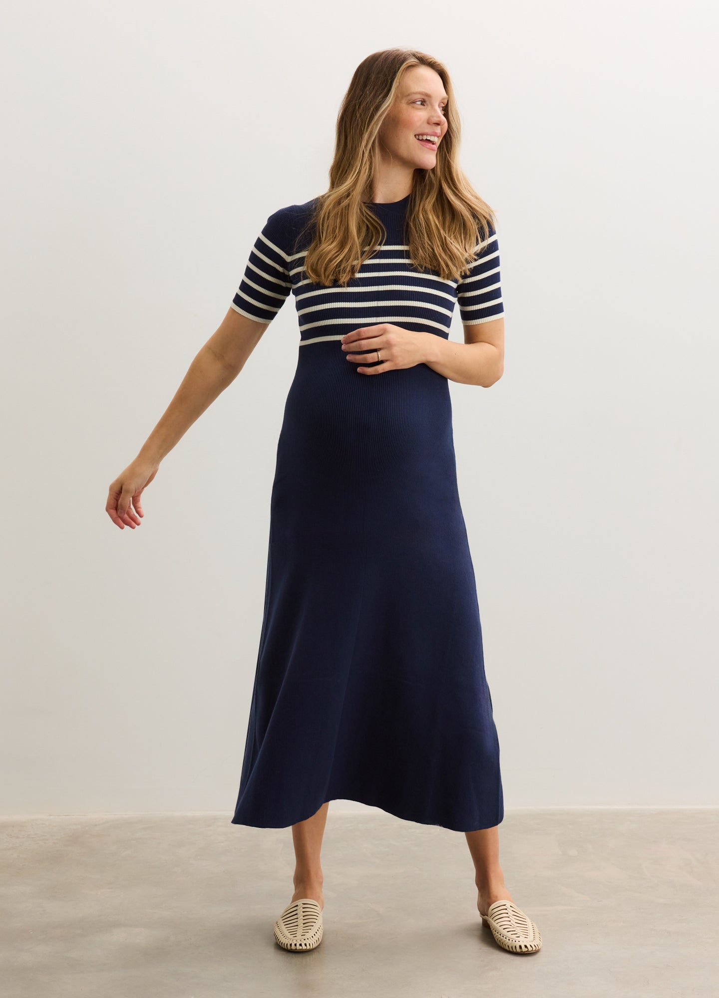 Navy and white striped maternity ribbed cotton dress with short sleeves and a fitted silhouette.