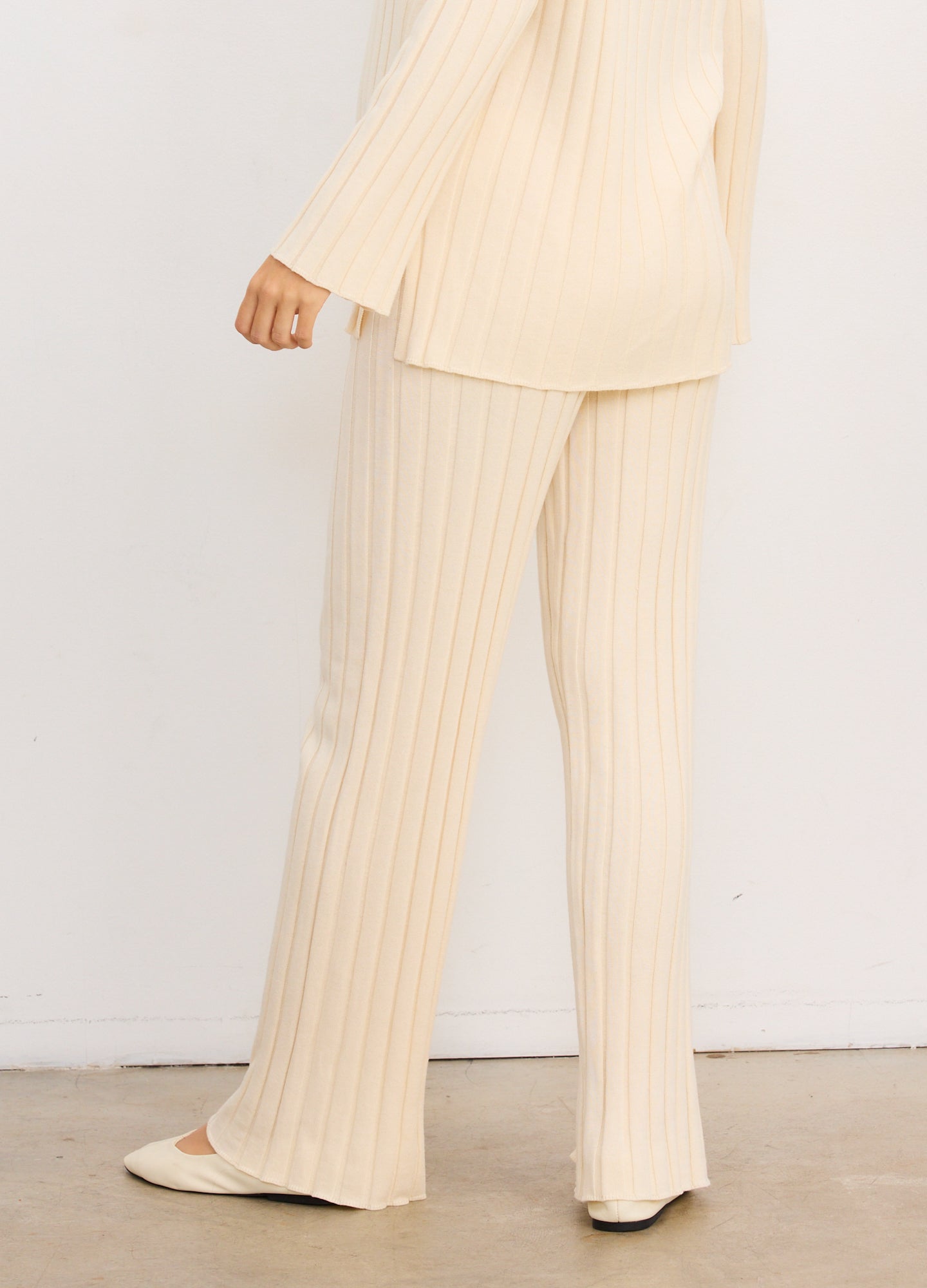 Beige ribbed knit maternity pants with wide-leg cut and soft, stretchy fabric designed for comfort during pregnancy.