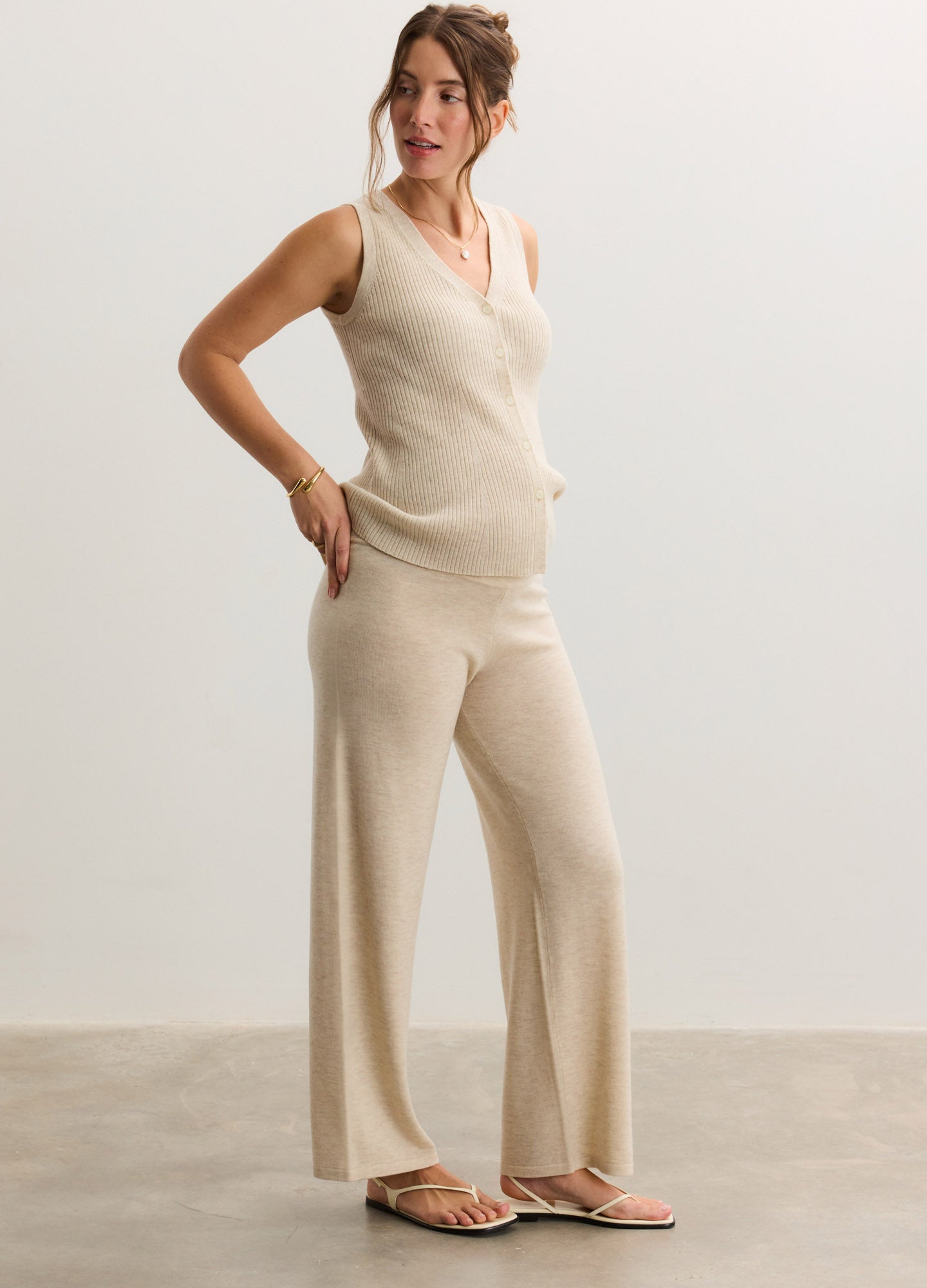 Beige knit maternity tank top with wide straps and a V-neck, styled with matching knit wide-leg pants.
