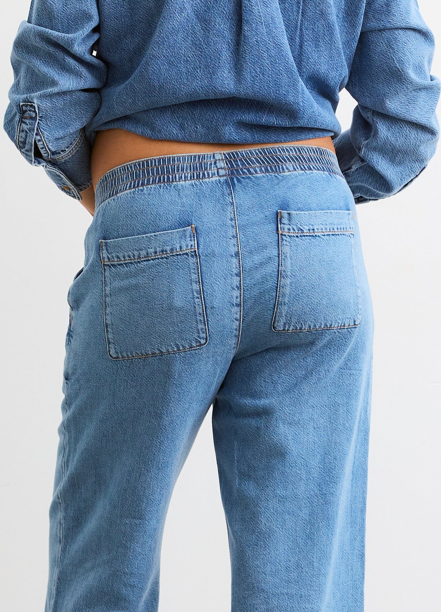 The Ellie Denim Pant - Light blue maternity denim pant with a stretchy waistband, relaxed wide-leg fit for pregnancy and postpartum comfort.
