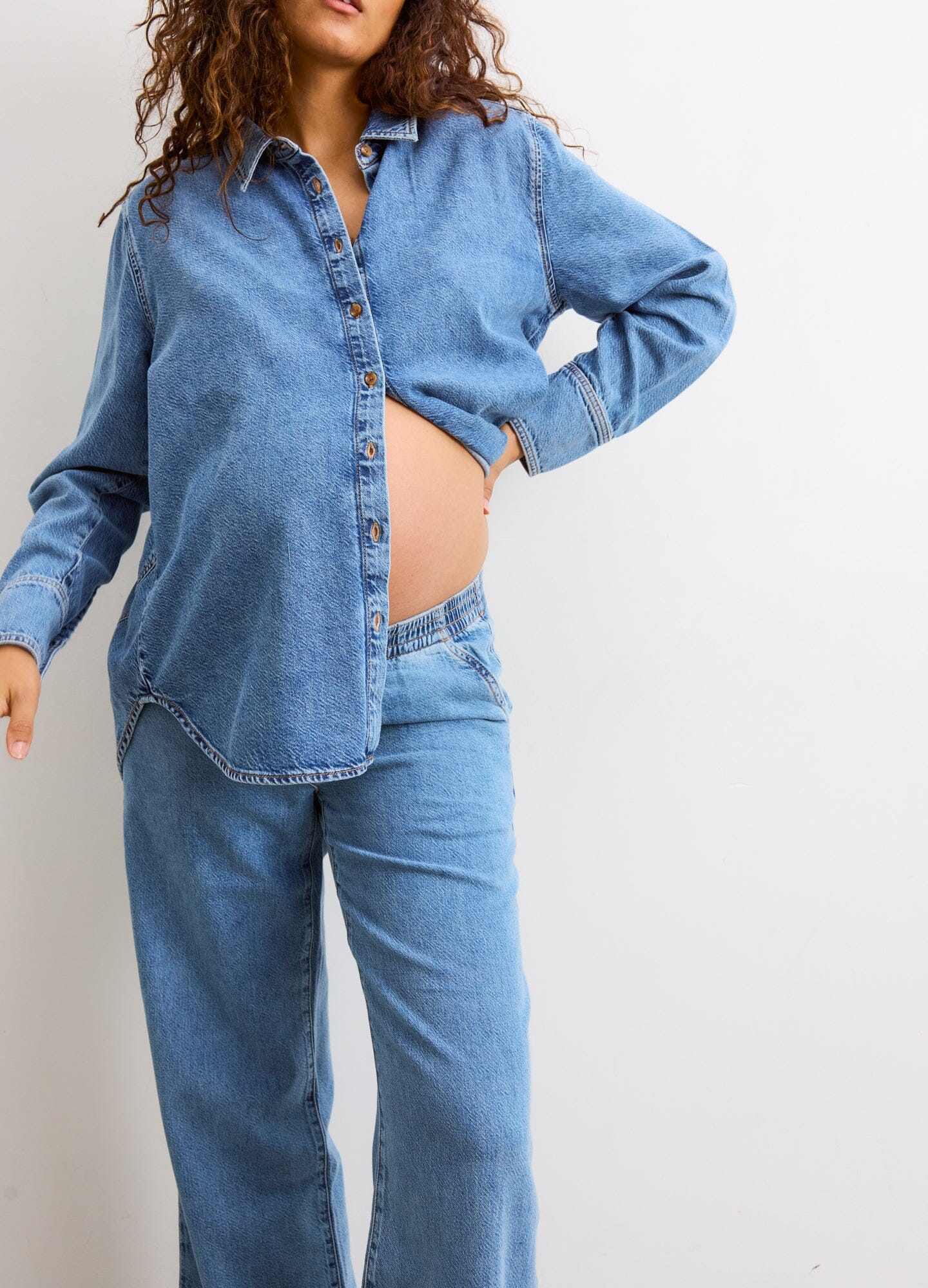 The Ellie Denim Pant - Light blue maternity denim pant with a stretchy waistband, relaxed wide-leg fit for pregnancy and postpartum comfort.