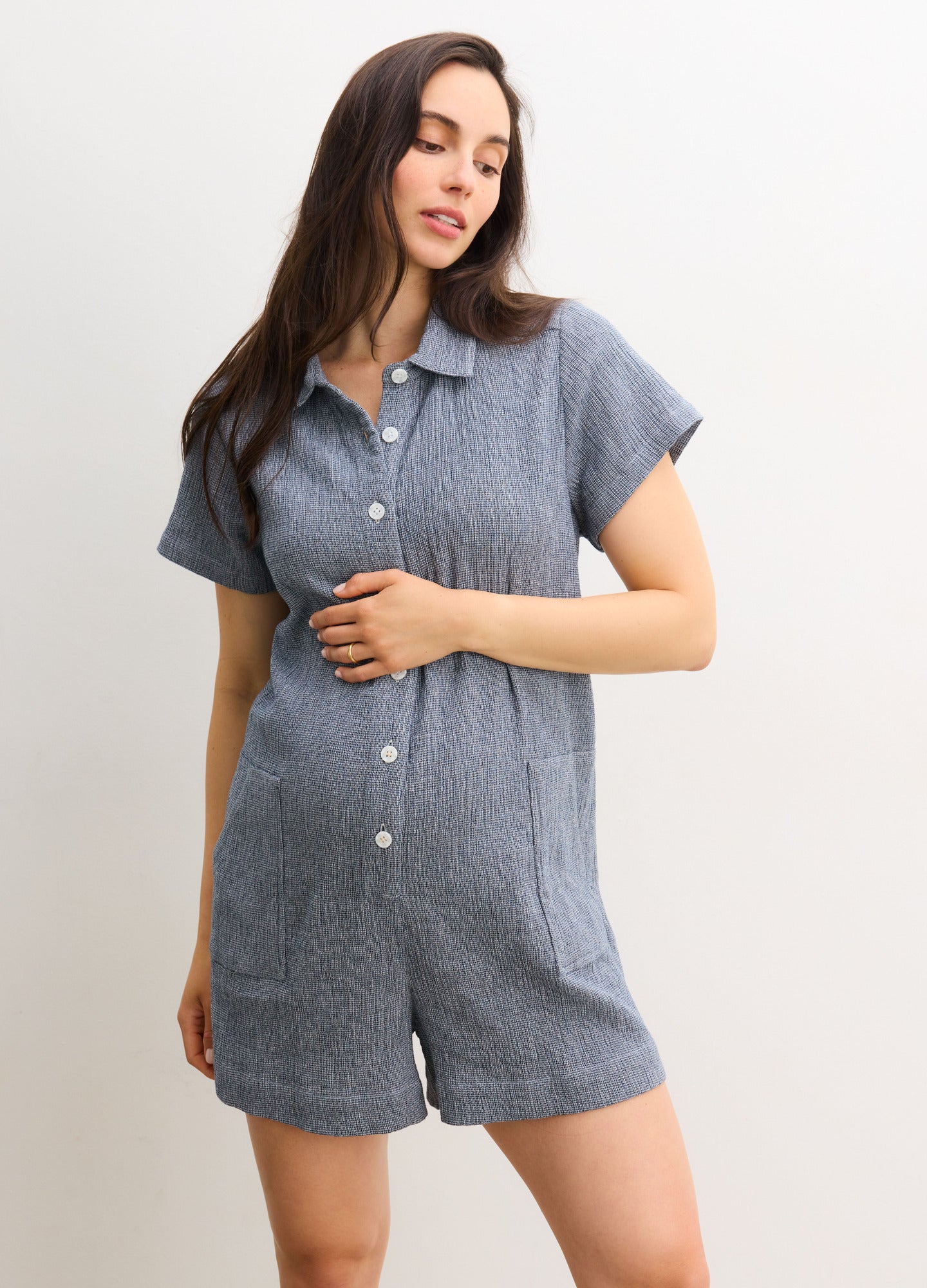 The Lenora Romper - Navy blue maternity romper with short sleeves, button-front, collar, and pockets for nursing and postpartum comfort.