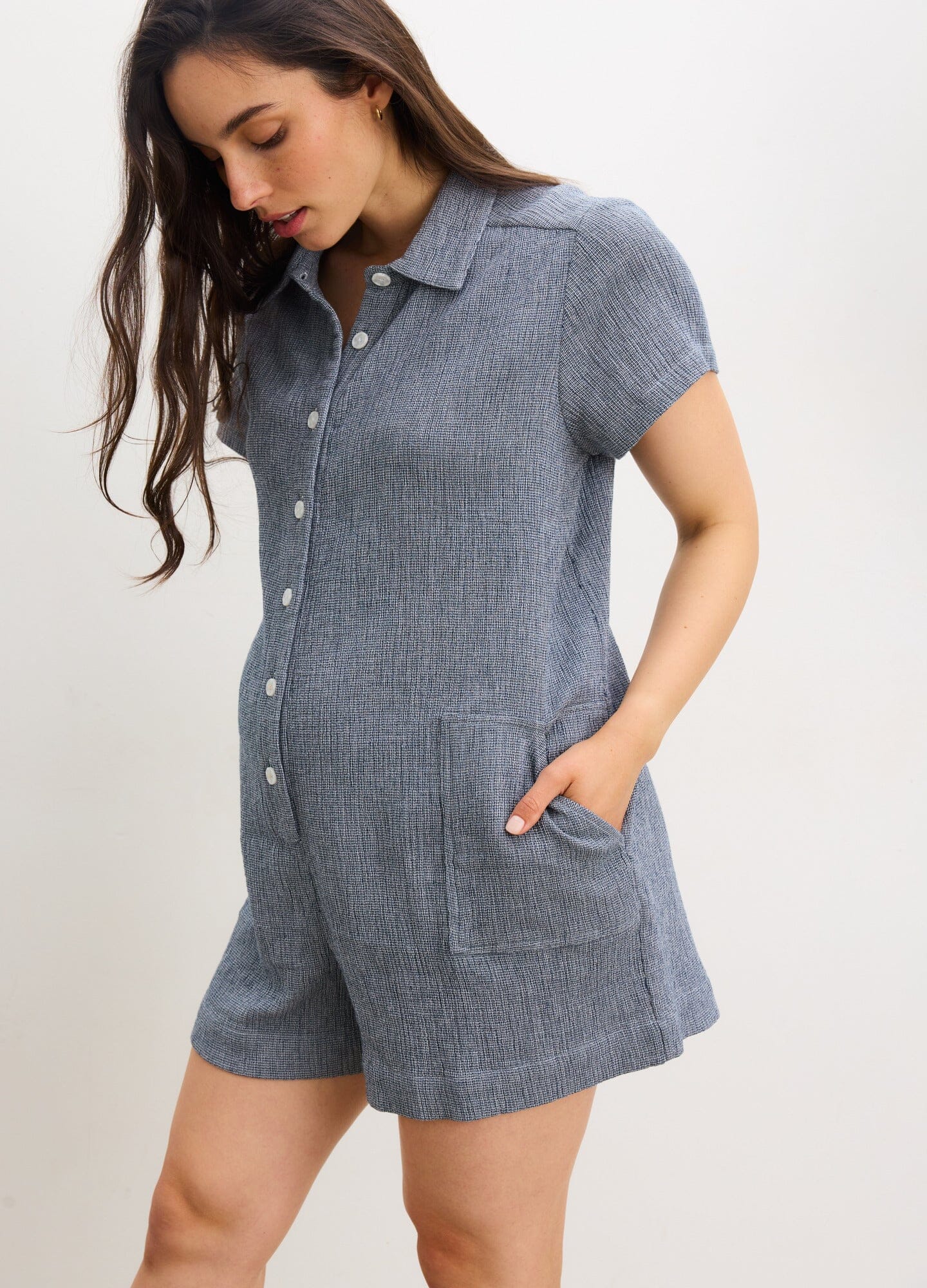 The Lenora Romper - Navy blue maternity romper with short sleeves, button-front, collar, and pockets for nursing and postpartum comfort.