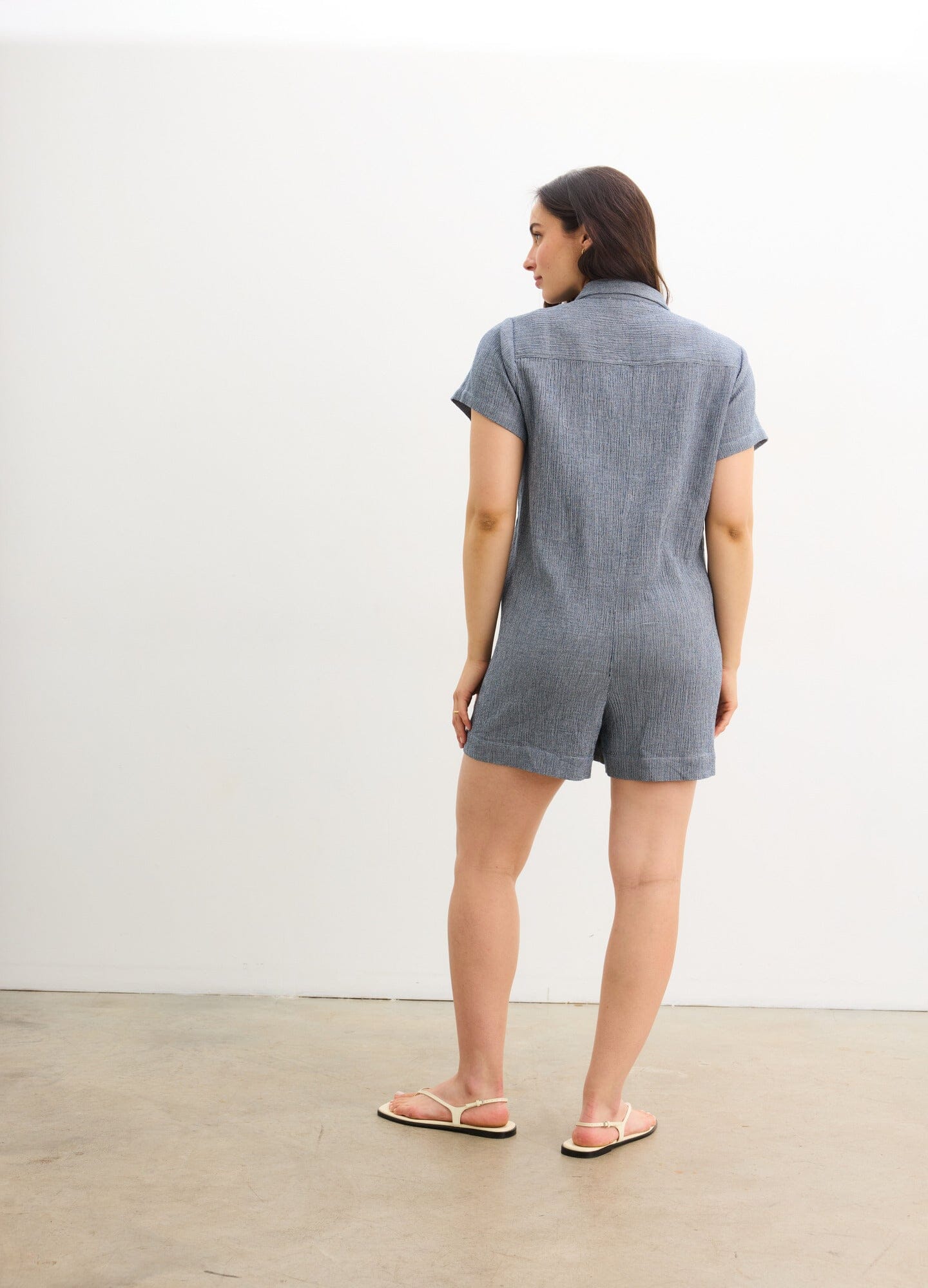 The Lenora Romper - Navy blue maternity romper with short sleeves, button-front, collar, and pockets for nursing and postpartum comfort.