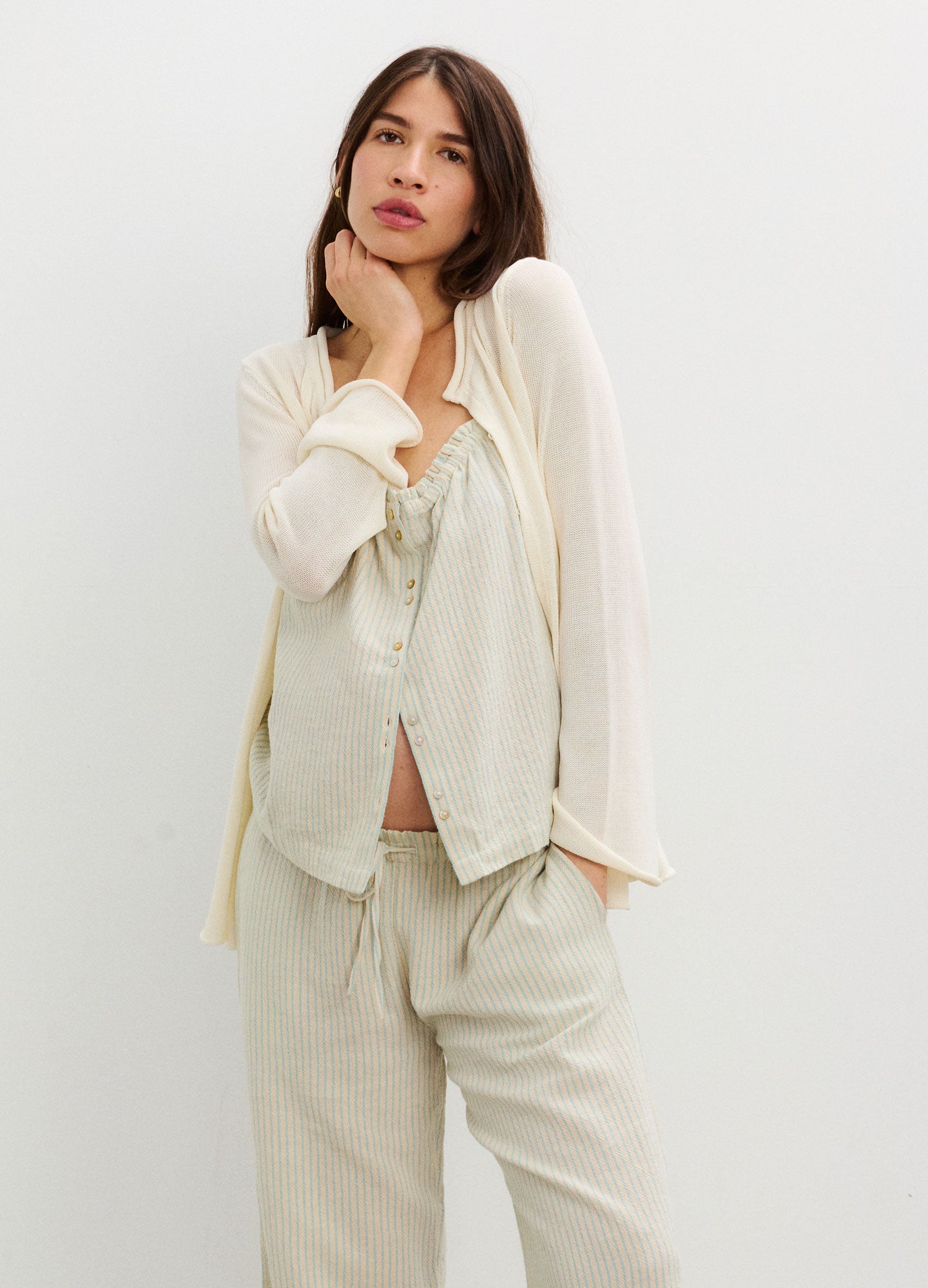 Cream-colored lightweight maternity top with delicate lace trim and button-down front, paired with matching loose pants.