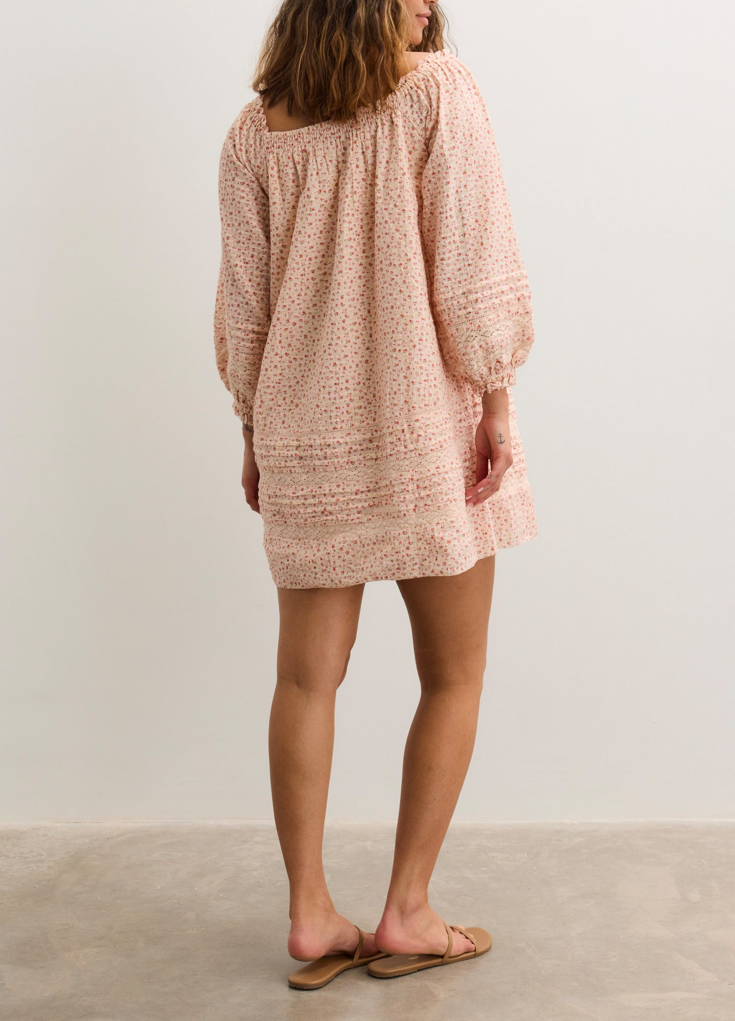 Light pink textured nursing mini dress with long puff sleeves and a loose, relaxed fit.